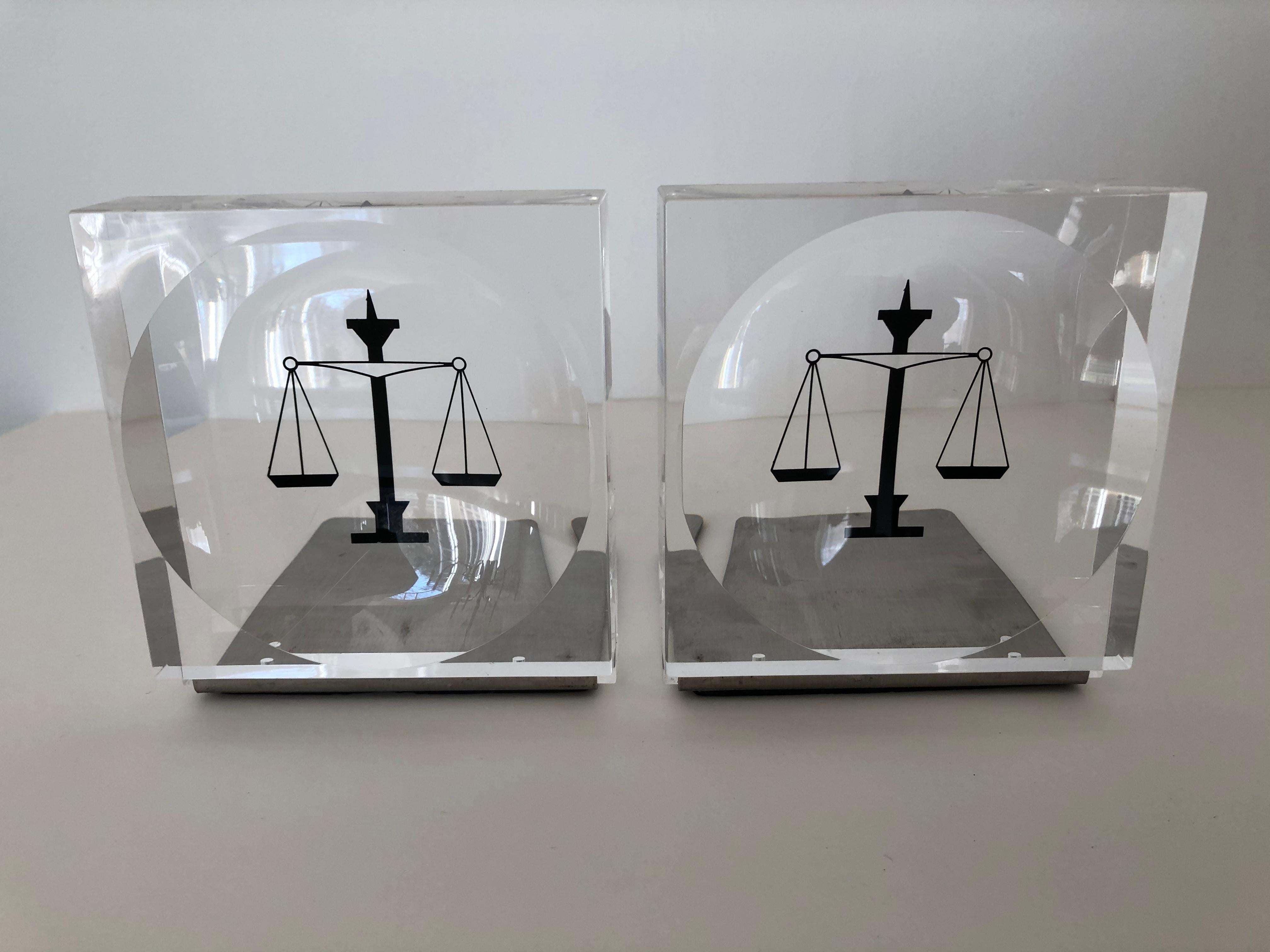 Lucite / acrylic black enameled scales of justice book ends, stainless steel return to fit books together as shown, nice for book display on shelving or desk. Rubber grips to bottom. Each book end measures 4.25 in depth, together with books about
