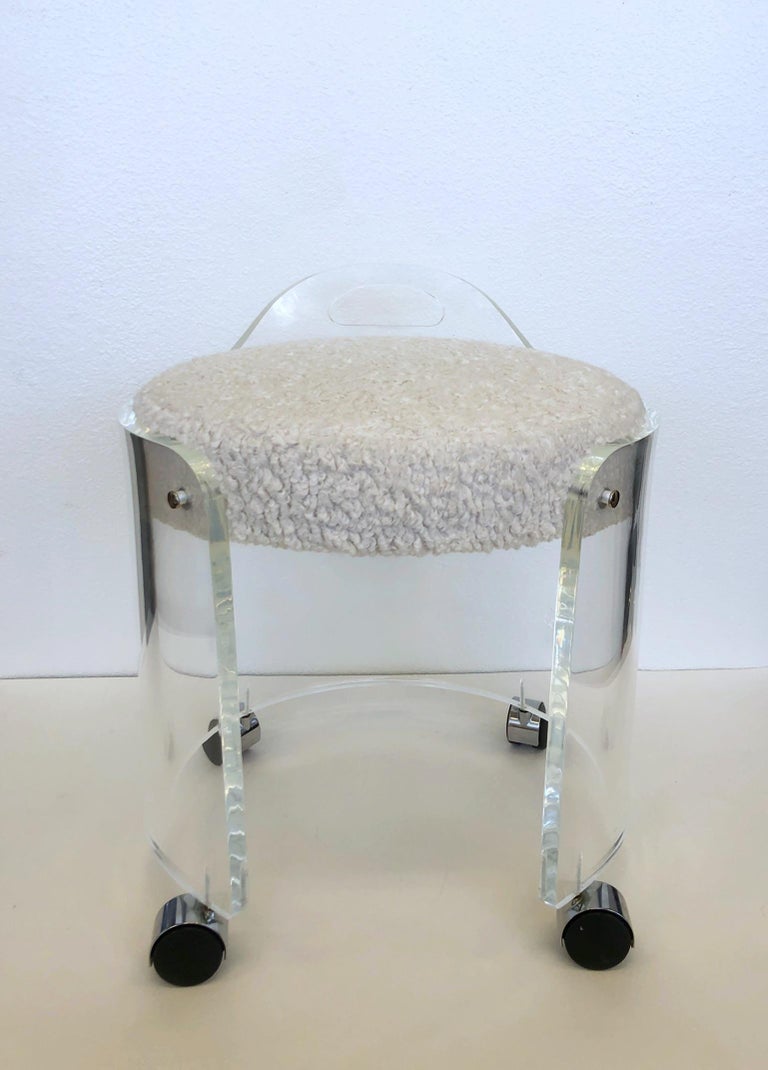 Glamorous 1980’s clear lucite with chrome details vanity stool on casters by Hill Manufacturing Corp.
In beautiful vintage condition, the seat has been newly recovered with a natural soft boucle fabric.
Measurements: 17” Wide, 16.25” Deep, 20”