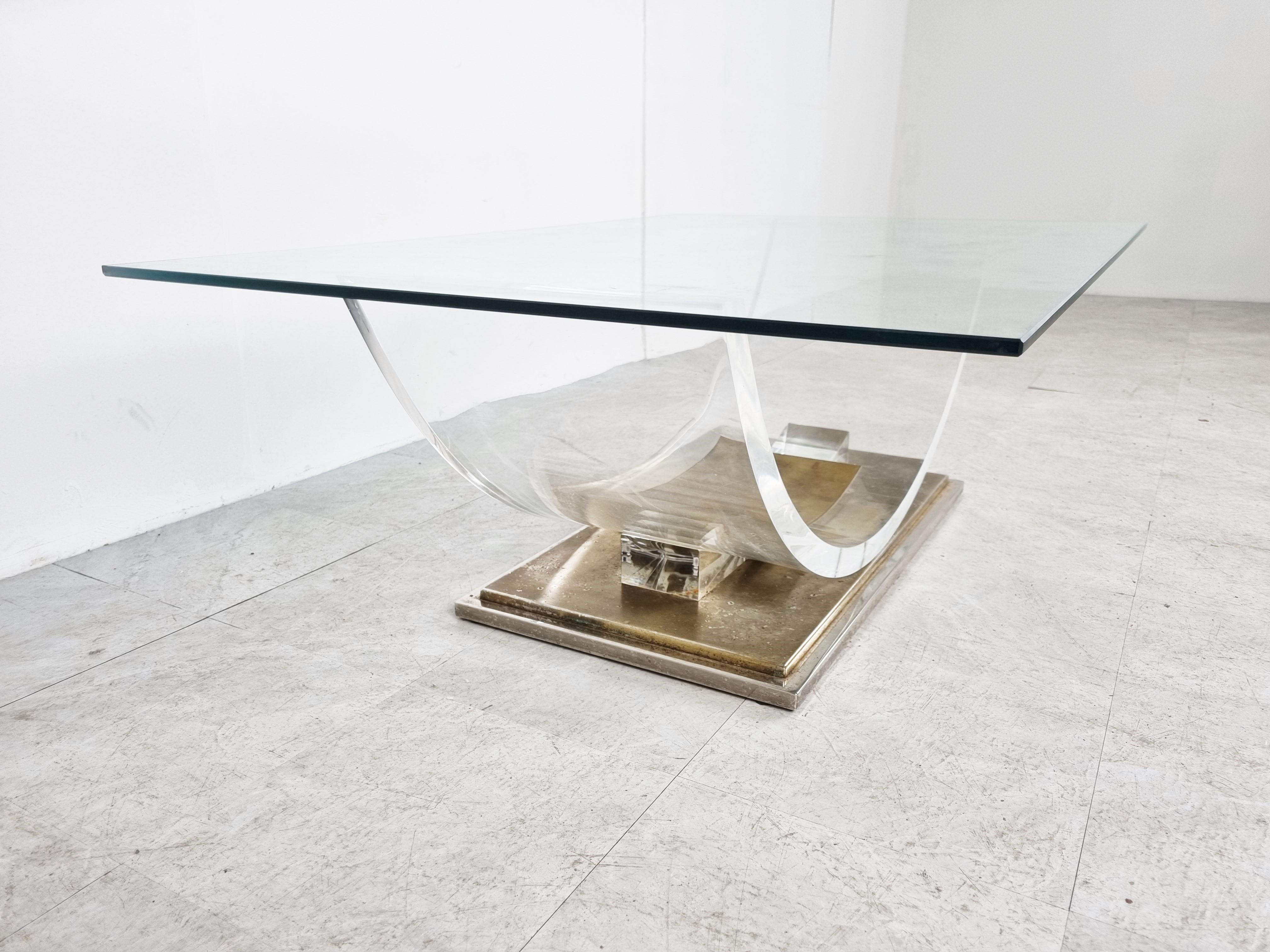 'arch' coffee table with a rectangular glass top in the by Charles Hollis Jonis and made by Belgochrom.

Made from a lucite frame mounted on a heavy brass base.

Patina on the brass.

1970s - Belgium

Dimensions:
Height: 40cm/15.74