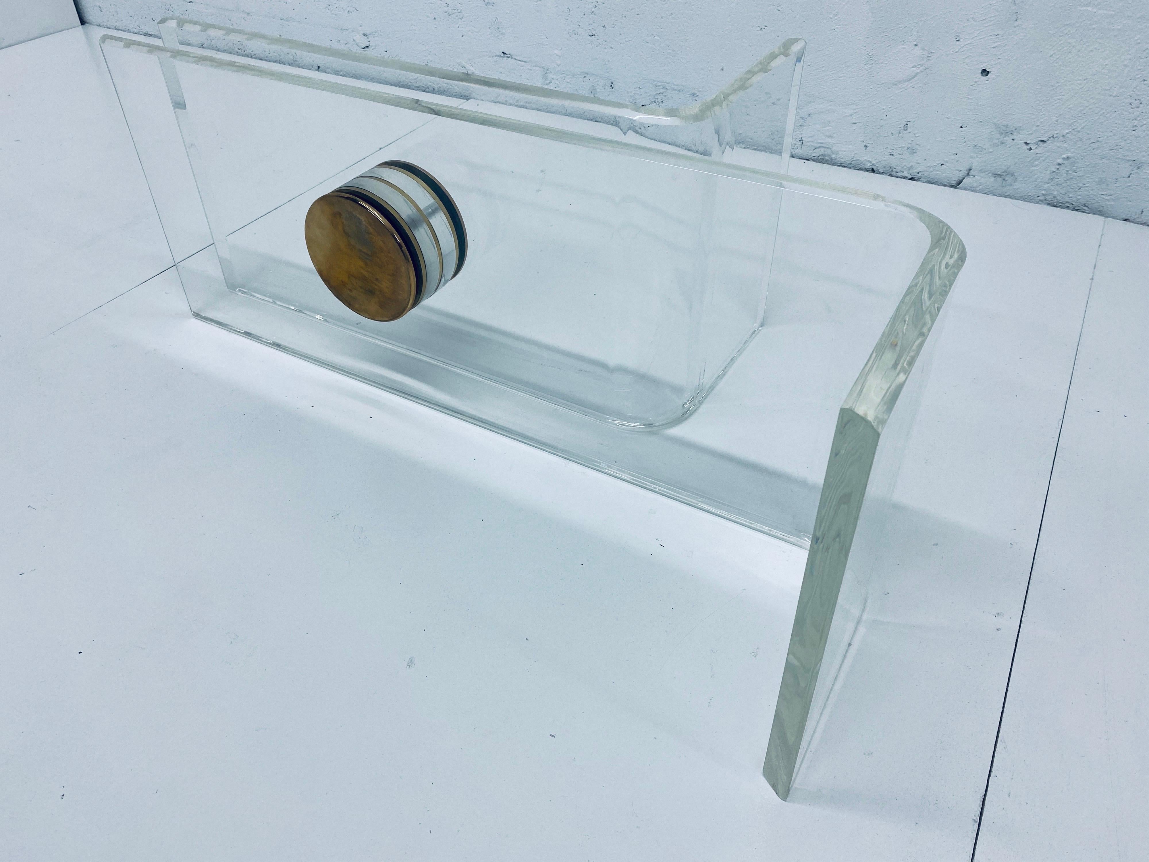 Sculptural lucite curved base with large brass caps coffee table base attributed to Karl Springer. One lucite piece is longer than the other. Table does not come with glass top (last image show what a larger glass top would look like with; 60