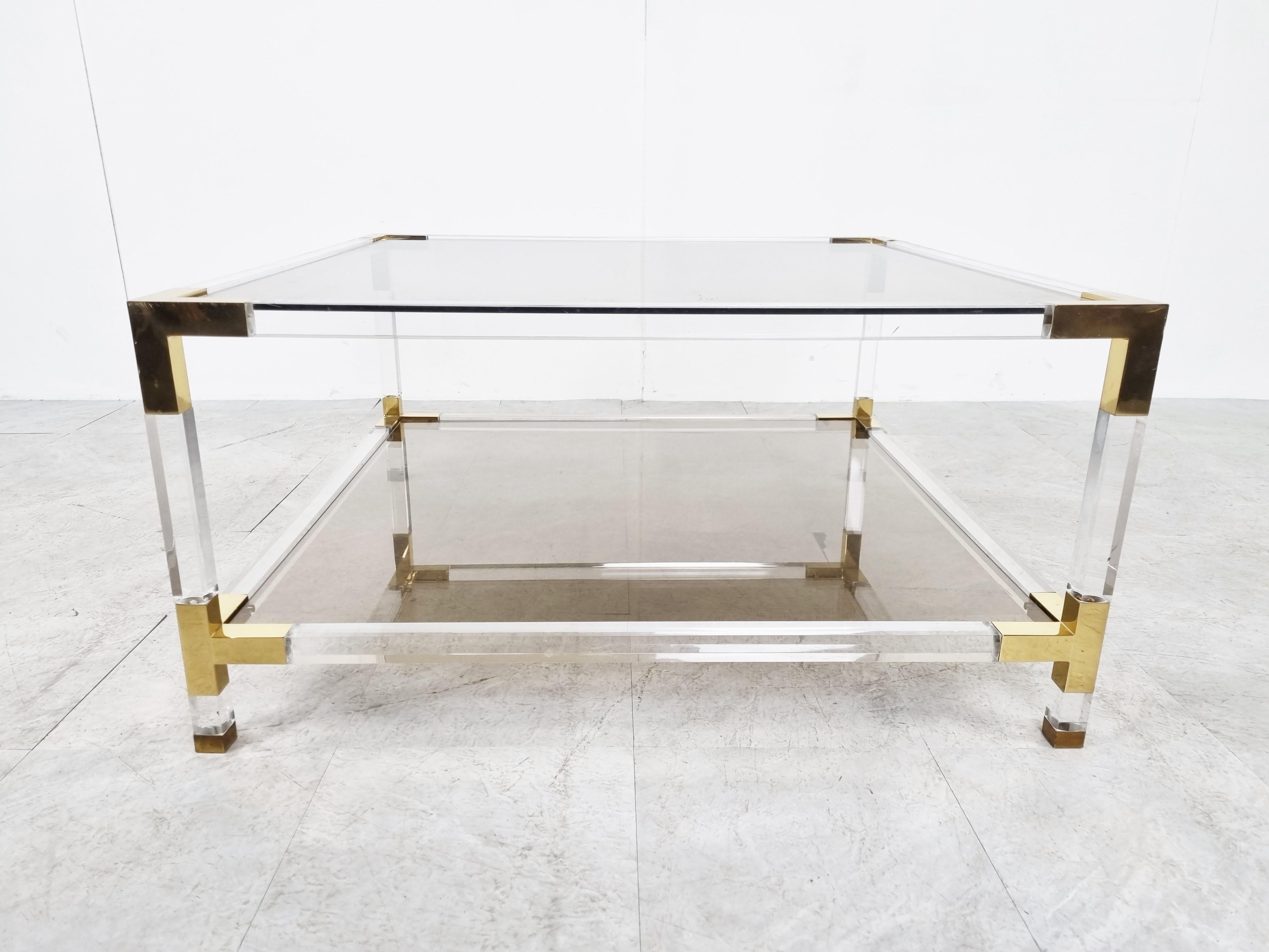 Small square coffee table with a lucite frame, brass corners and smoked glass plates.

Good condition.

Very modern looking and decorative table that can be combined with lots of interior styles.

Good condition.

1970s -