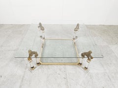 Lucite and brass coffee table with chinese temple guard sculptures, 1970s
