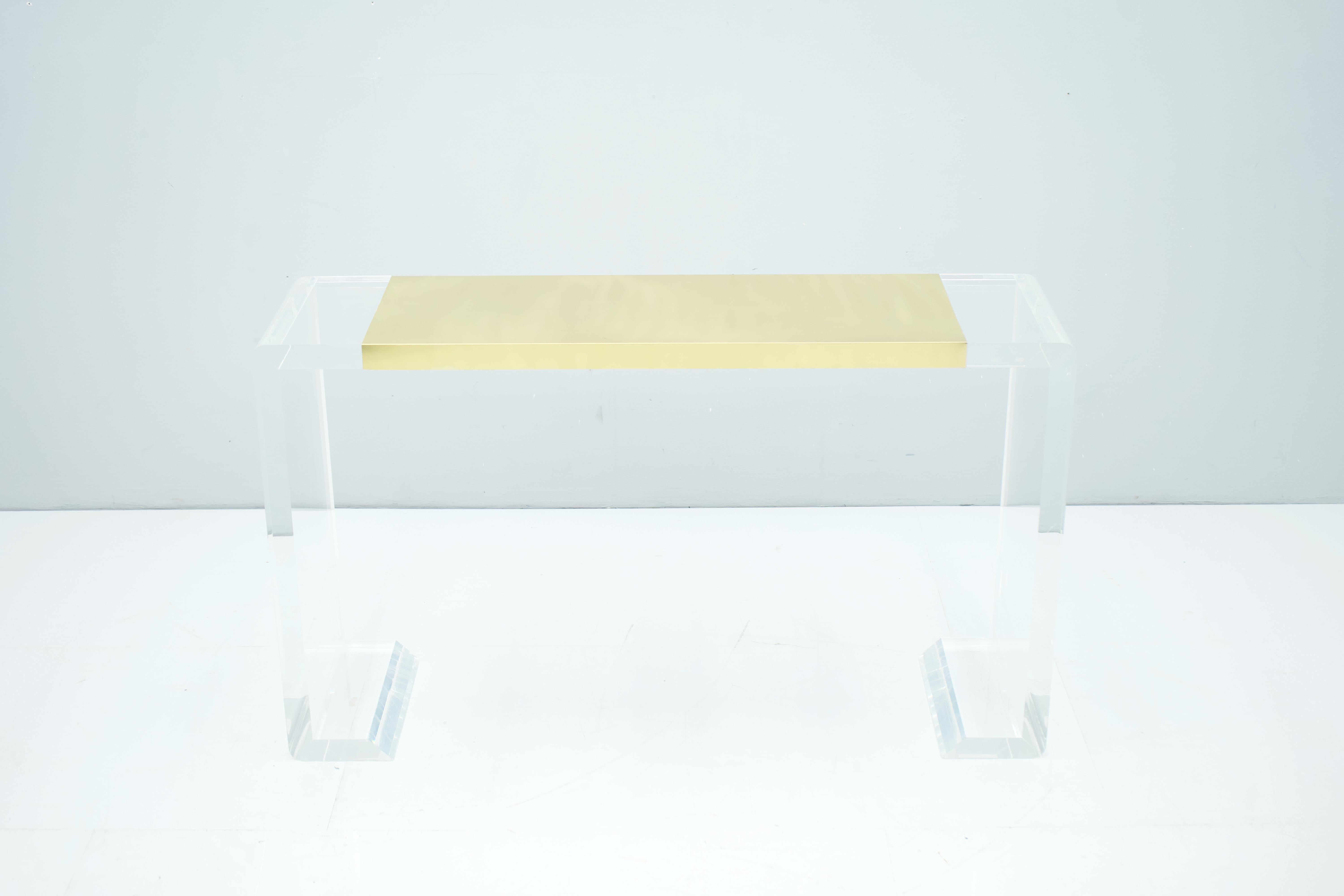 Very nice console table made of Lucite and brass. Very high-quality processed. Good to very good condition.