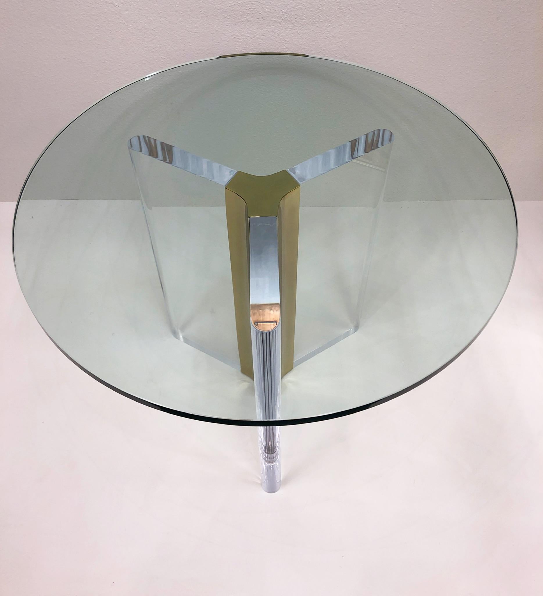 1970’s clear lucite and brass dining table with glass top table by renowned American designer Charles Hollis Jones.
Newly professionally polished. 
The glass top showing is 3/4” Thick 35.75” Diameter.