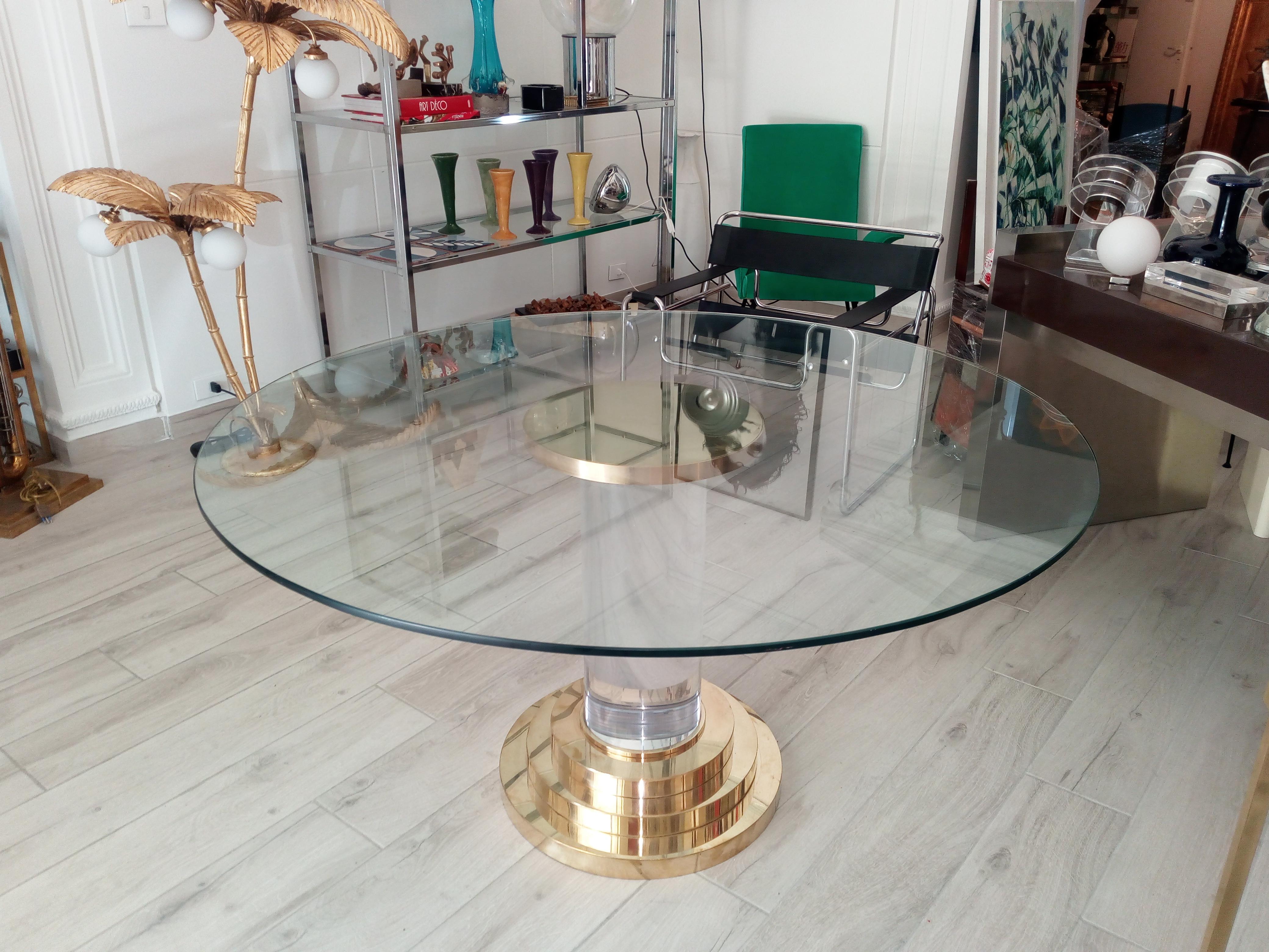 Lucite and brass dining table with cm.140 diameter glass top in the style of Romeo Rega.
Base is about cm.40 diameter on top and cm.55 diameter on bottom
Made of polished brass with cm.22 diameter thick Lucite.
 
