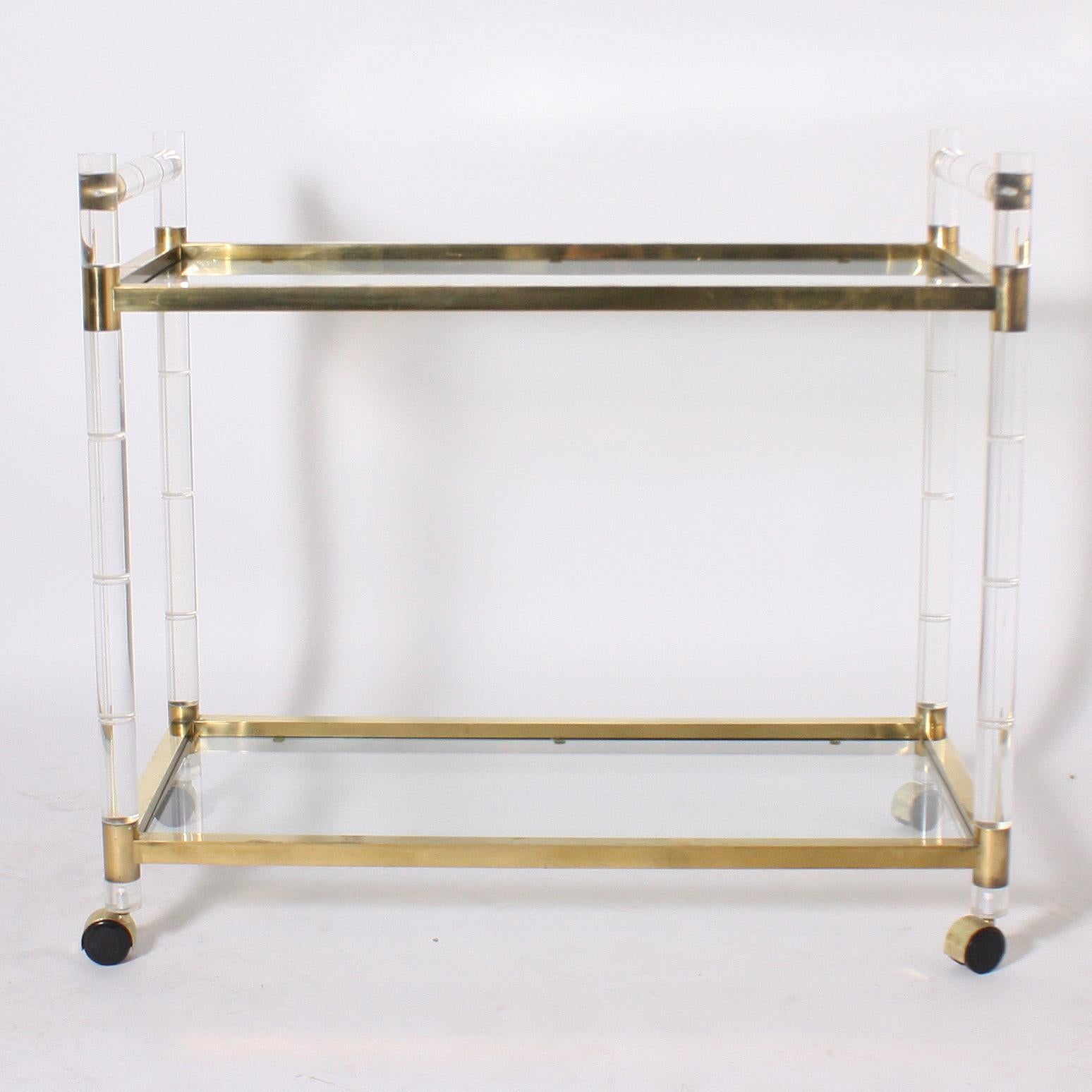 Lucite and brass faux bamboo drinks cart, circa 1970.
Measures: 37” W x 18 3/4” D x 33” H.