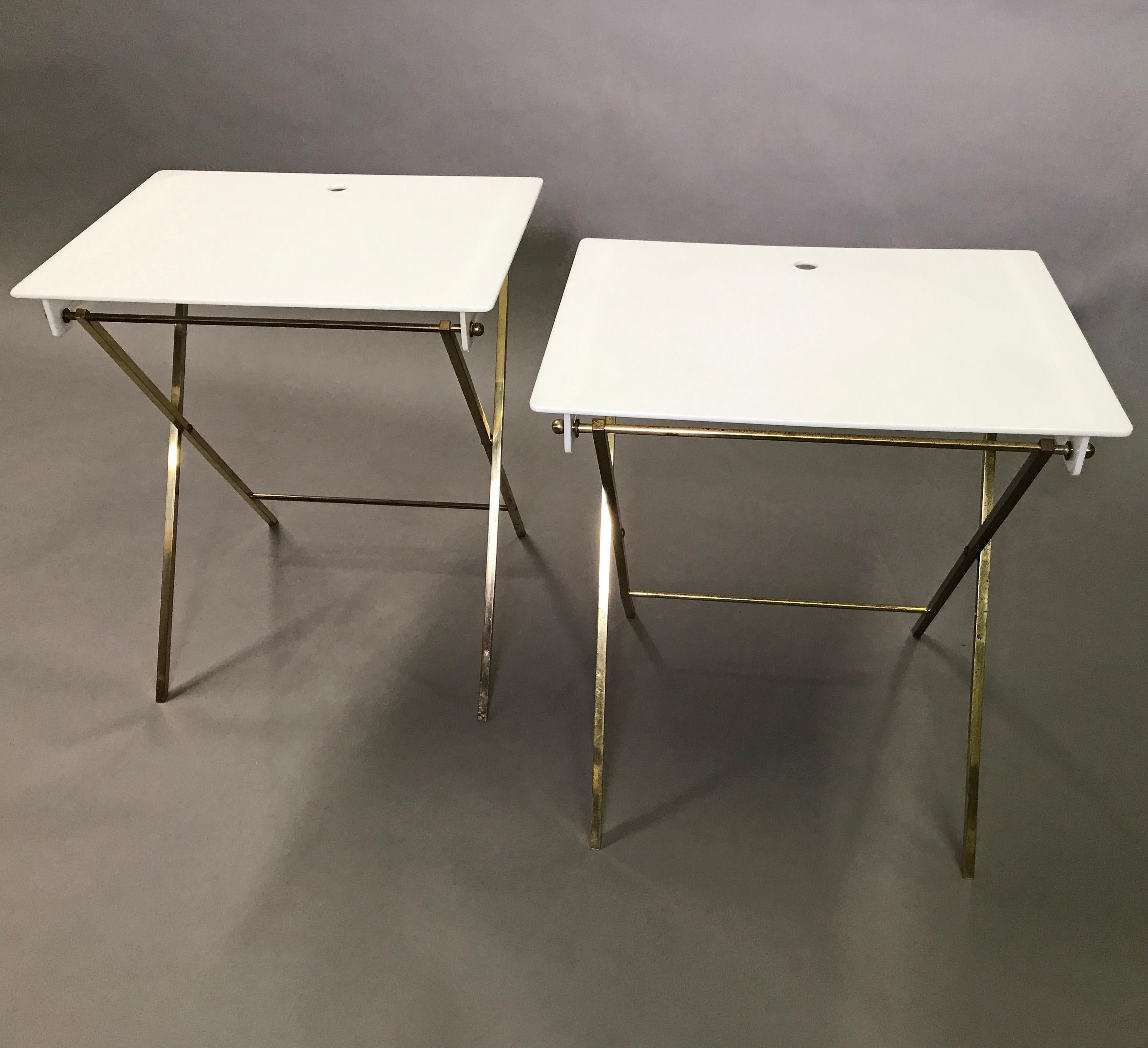 Pair of Mid-Century Modern, folding, tray tables by Charles Hollis Jones feature brass X-bases with white plexiglass tops.