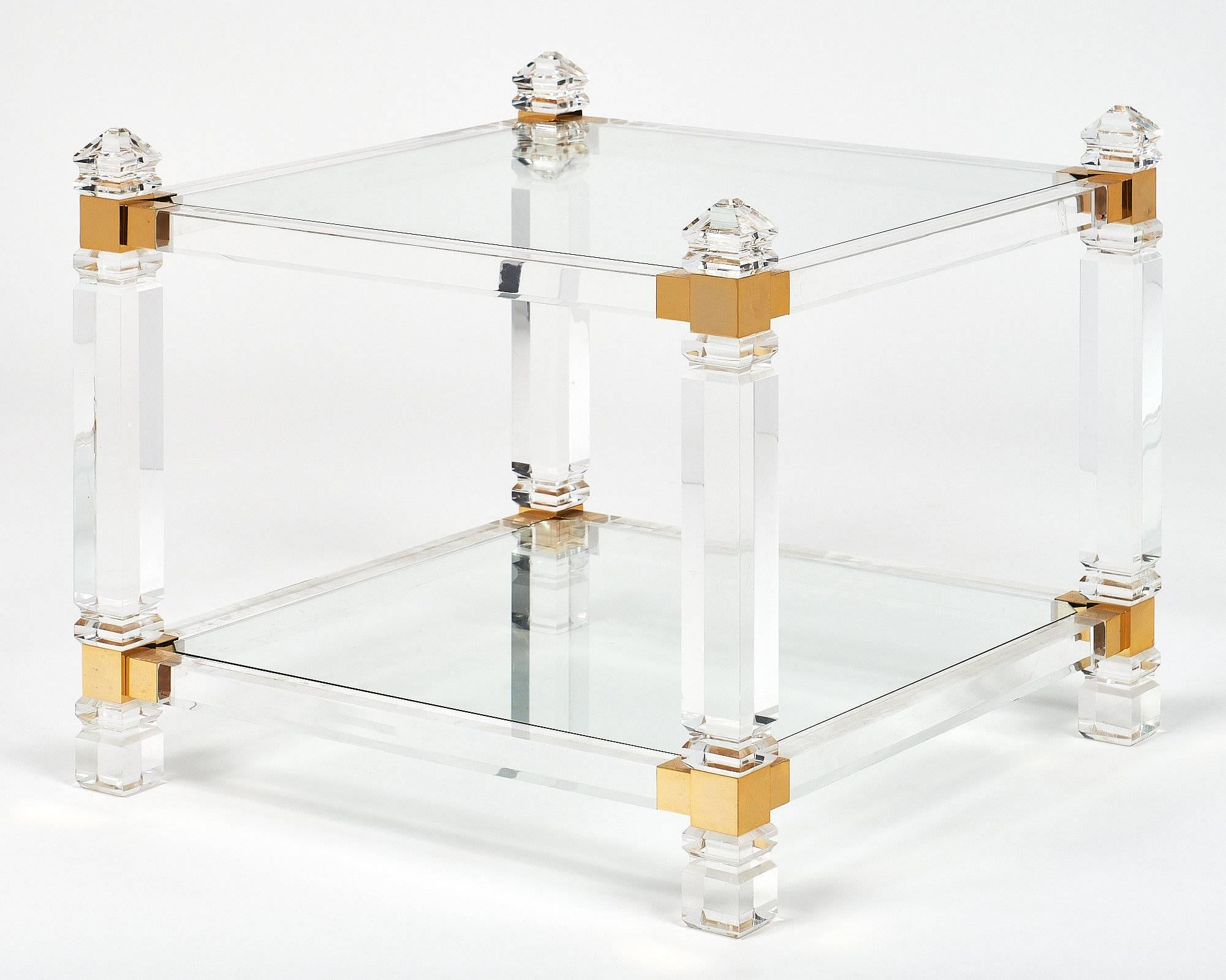French Modernist Lucite and brass side tables. This pair is elegant and bold! The perfect side tables, or could be presented side by side as a coffee table as well. We loved the rich complex structures playing with angles, transparency and light.
