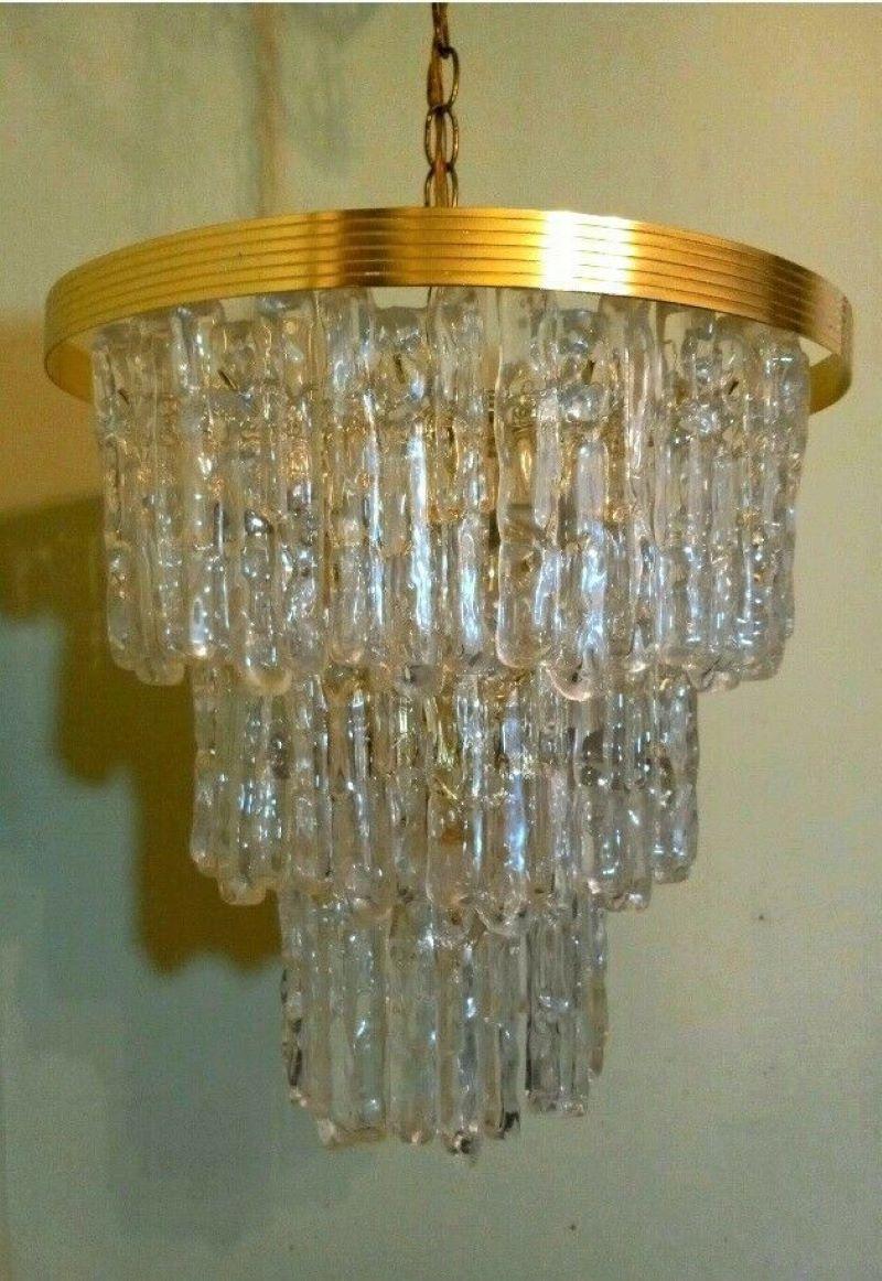 Lucite And Brass Kalmar Style three-tiered Icicle Chandelier. Eight candelabra base sockets. Measures 17