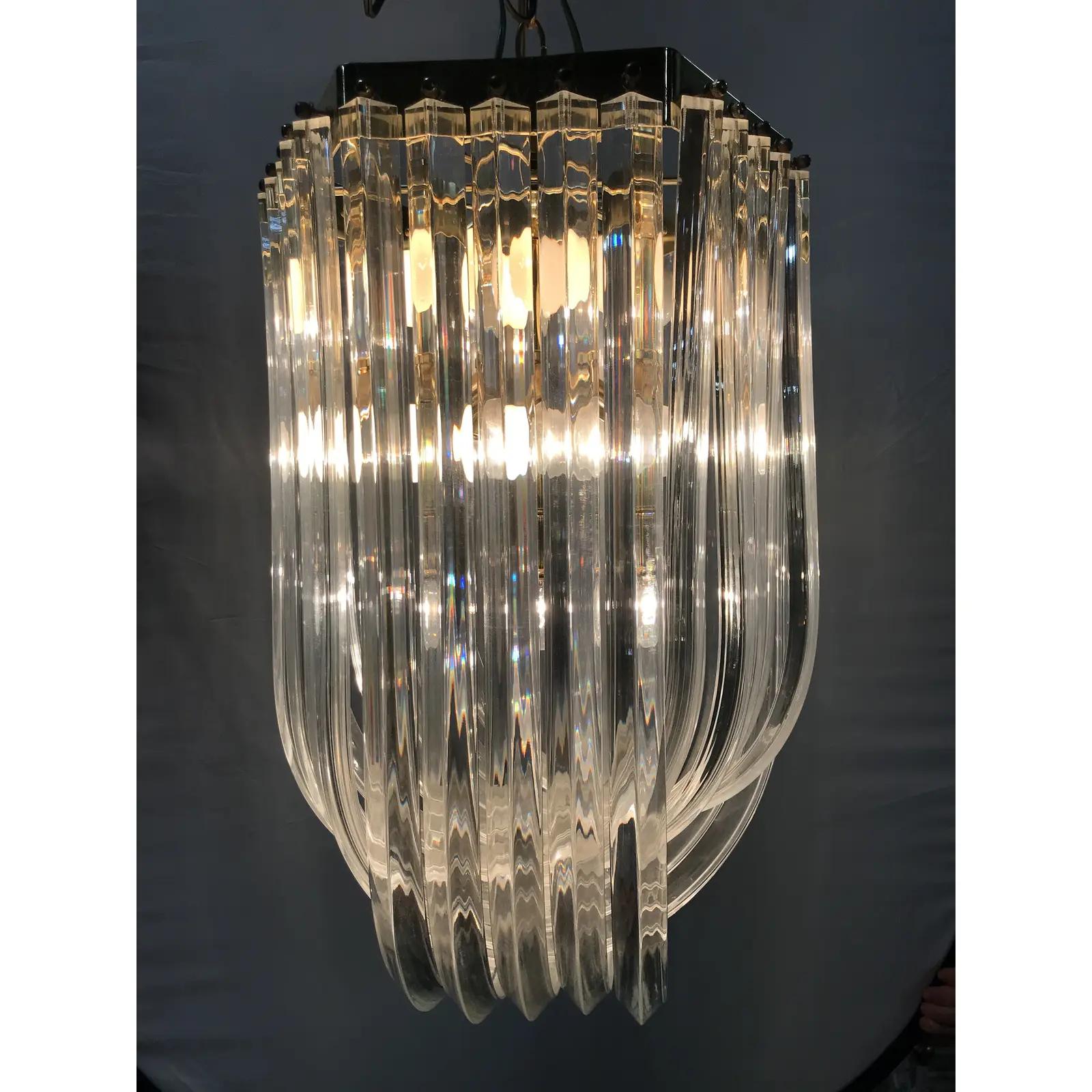 Mid-Century Modern Lucite and brass ribbon chandelier with canopy.
Wired for the U.S. and in excellent working condition.