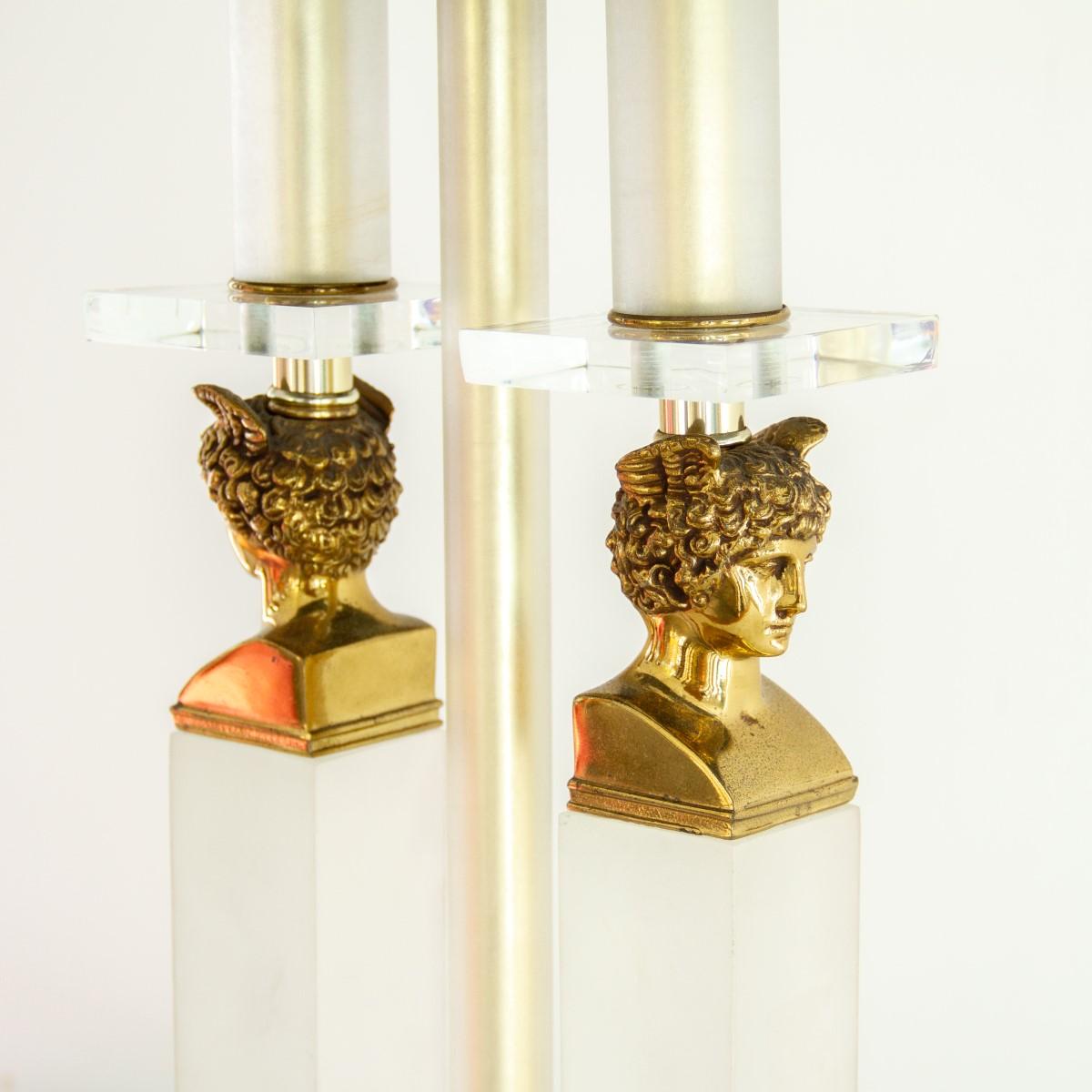 A single neoclassical style lamp with two frosted lucite columns, topped with brass coloured Hermes heads and sat on a clear and frosted lucite base, 1970s.

Light scratches and tarnishing. 

Currently on display in our London Collection, at The