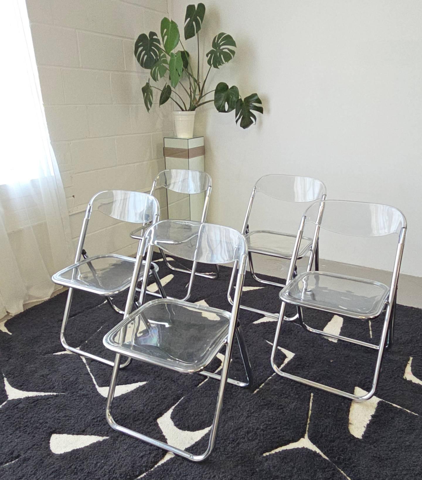 Lucite and chrome folding chairs are attributed to Brevettato. The body is made in chrome with lucite backrest and seat. The lucite seat is removable. They're made in the 1970s in Italy. These chairs are perfect for small spaces and easy to store.