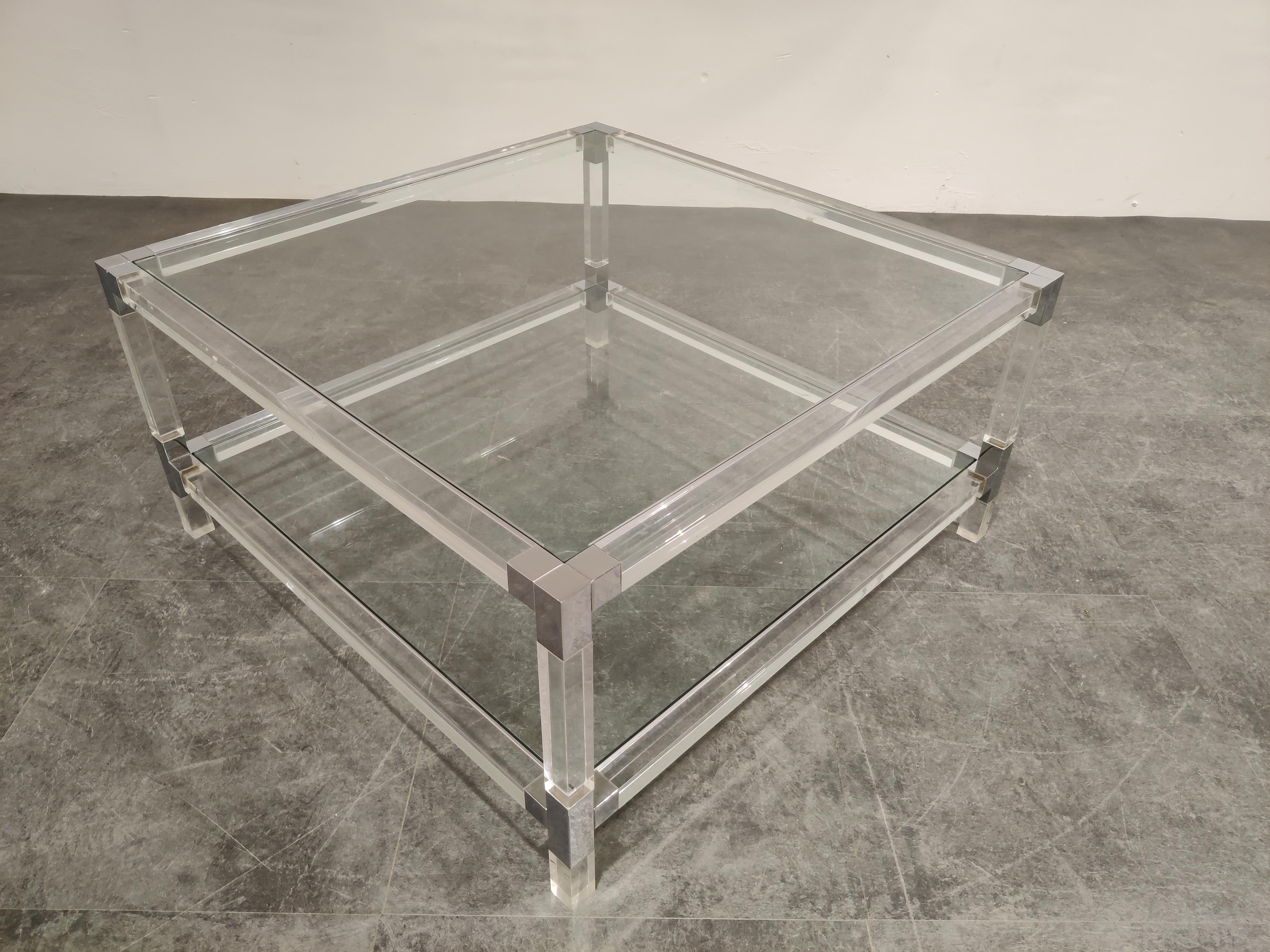 Square coffee table with a Lucite frame, chromed metal corners and clear glass plates in the style of Charles Hollis Jones

Good condition.

Very modern looking and decorative table that can be combined with lots of interior styles.

Good