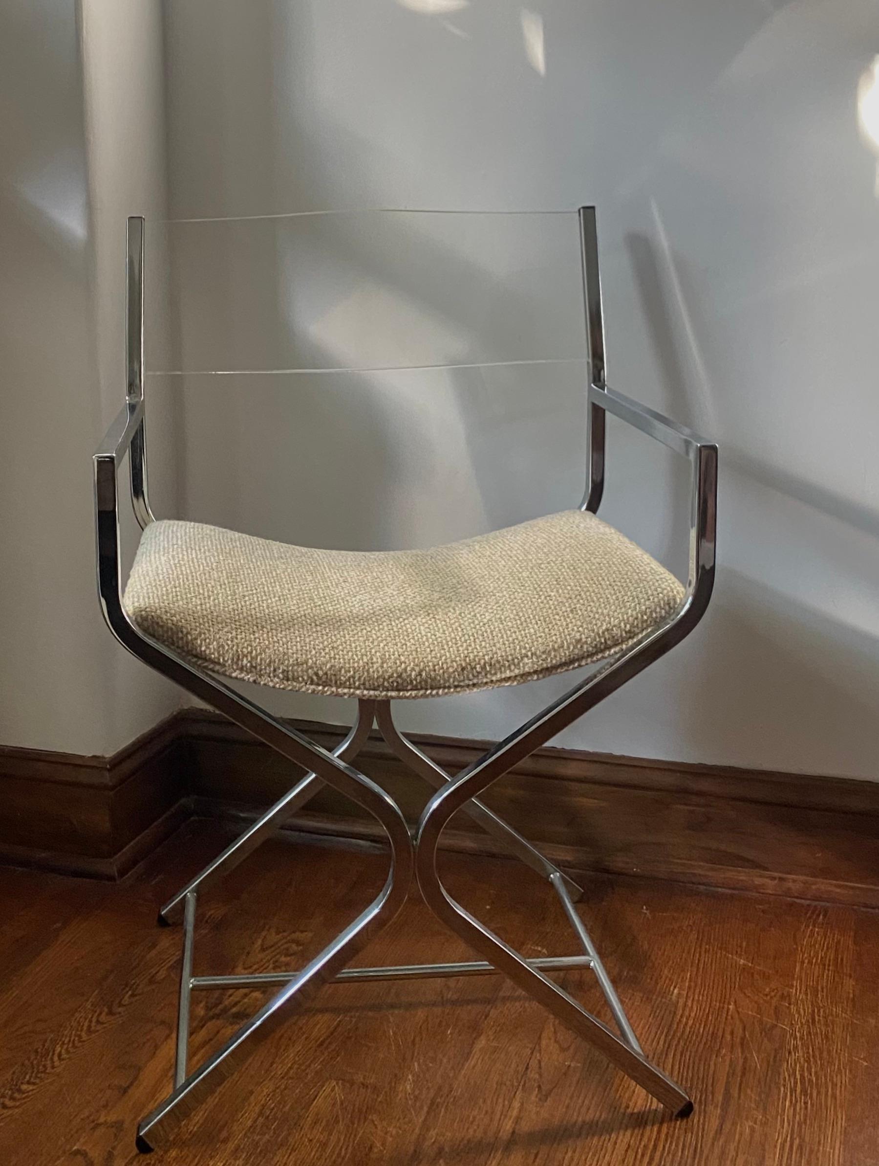1970s Lucite and Chrome X directors chair - this vintage director's chair is a true testament to timeless design. With its sleek chrome frame, lucite backrest, and oatmeal seat cushion, it embodies the clean lines and modern aesthetic of mid-century