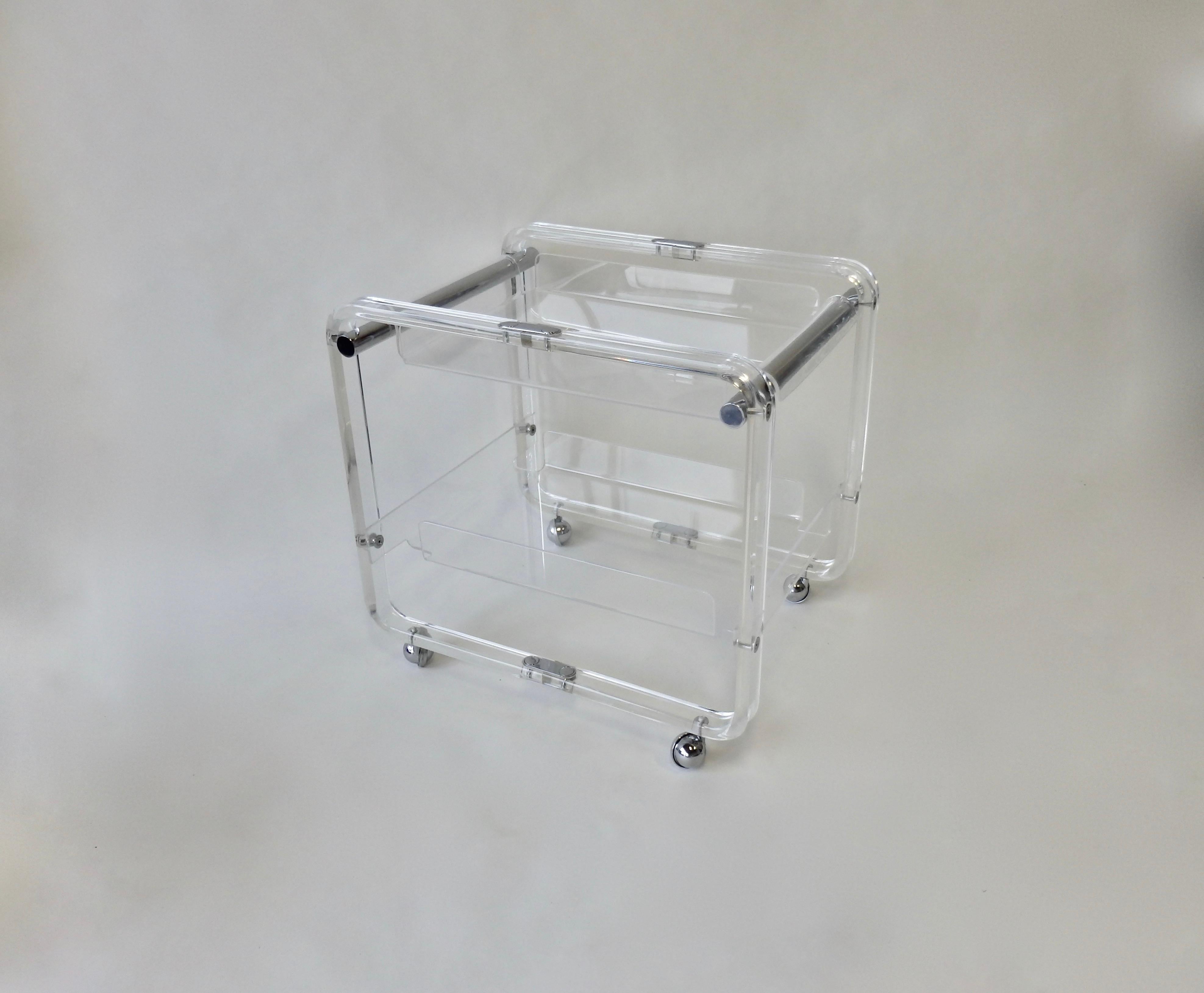 Charles Hollis Jones style Lucite bar or tea cart. Two tiers with upper level made to lift off as serving tray. Nicely machined chrome fasteners act as detail throughout. Rolls on chrome ball casters.