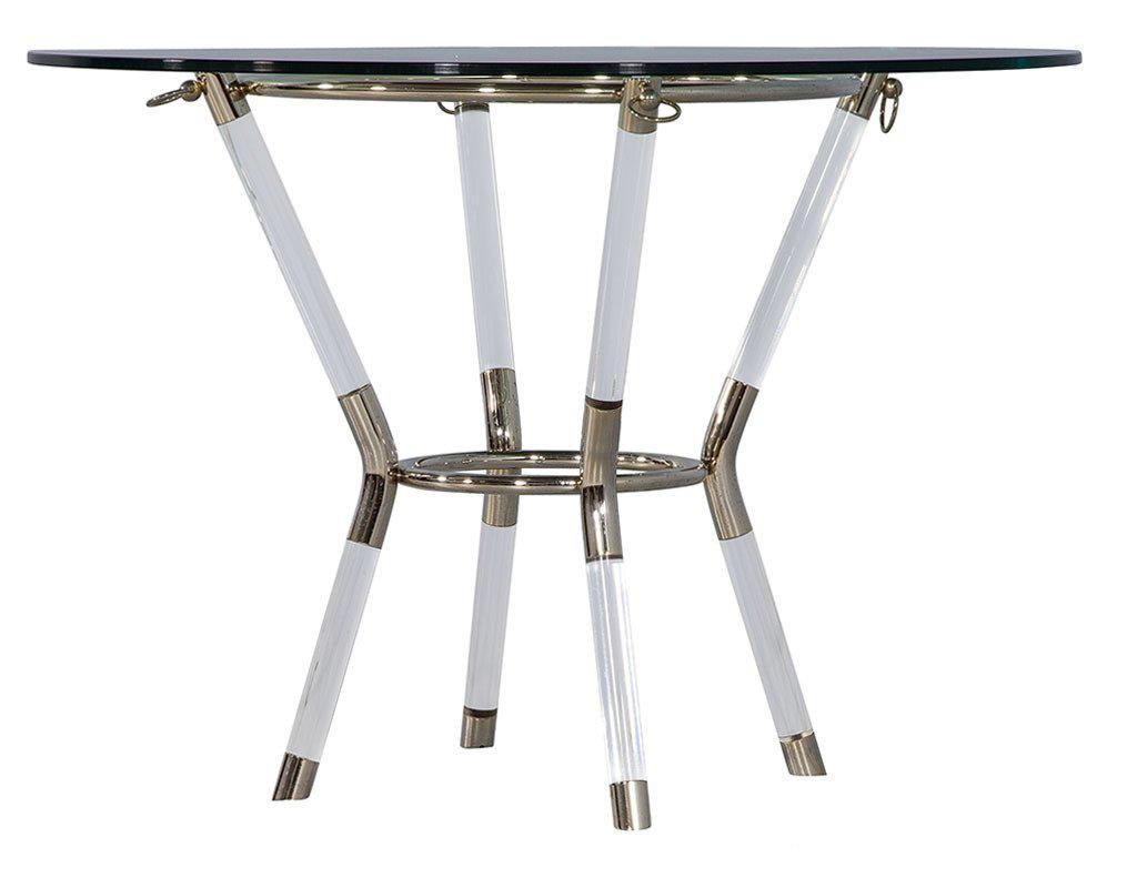 A chic contemporary end table that borrows some of the visual style of the 70s with its clear Lucite and shiny chrome structure. Consisting of four bent lucite pipes with circular ties at the top and center supporting glass tabletop. Chrome sleeves