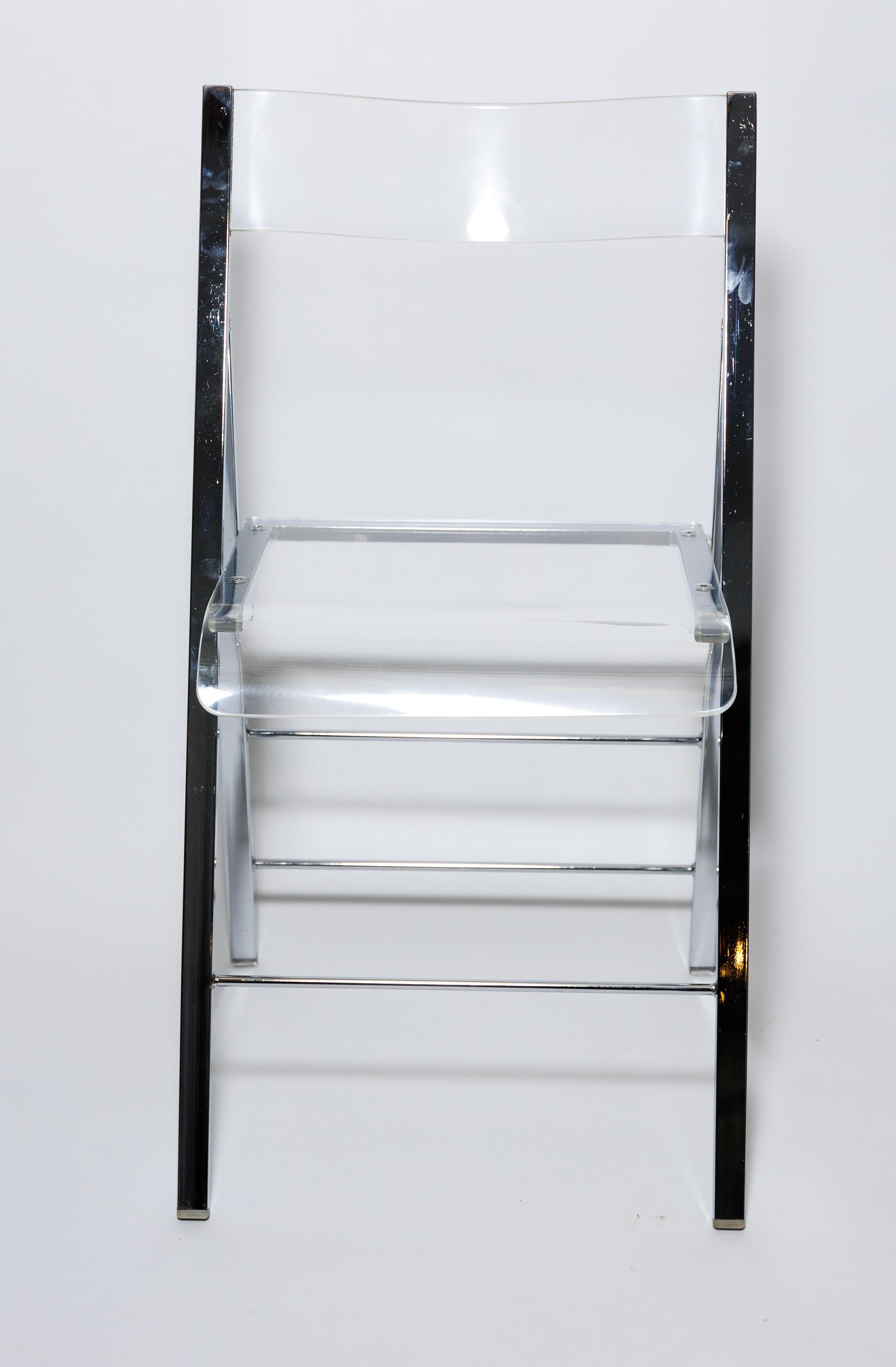 A Lucite and chrome folding chair, whenever you need extra sturdy seating.
Four available.