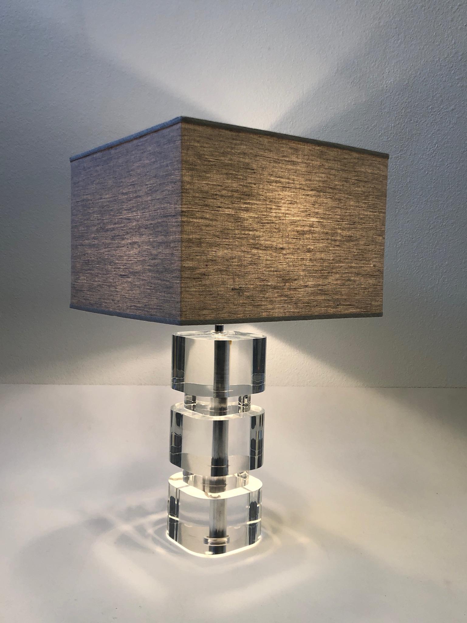 1980s glamorous clear Lucite and polish chrome table lamp by renowned American designer Karl Springer. Newly rewired and new oatmeal linen shade. The acrylic shows some crazing from age(see detail photos).
Measurements: 16” wide, 16” deep and 27”