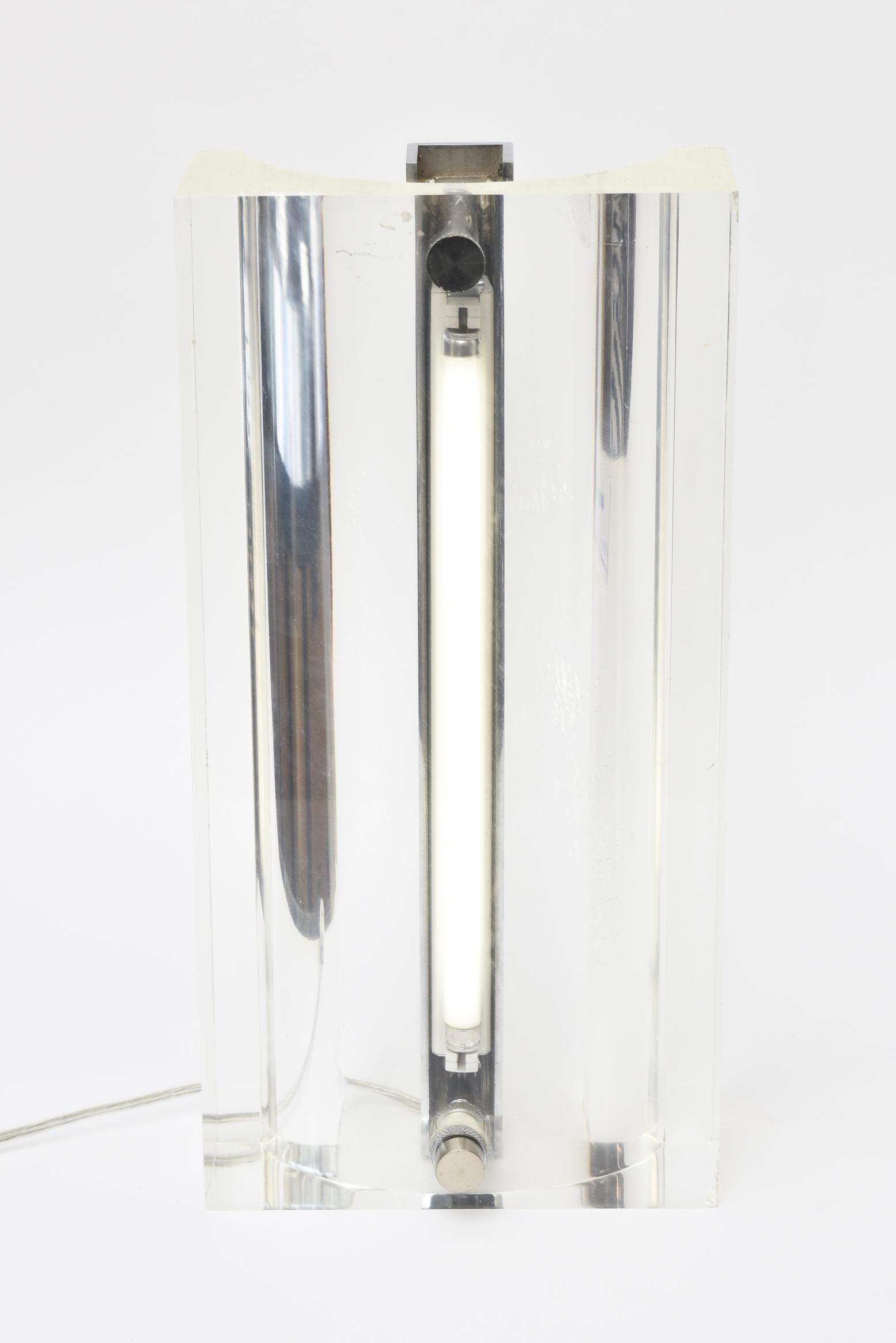 This vintage European 1970's lucite and chrome column table lamp has been rewired for American lighting and has a fluorescent bulb. It came from England. It is open in the back. It is one lamp although looks like 2. It is very sculptural.