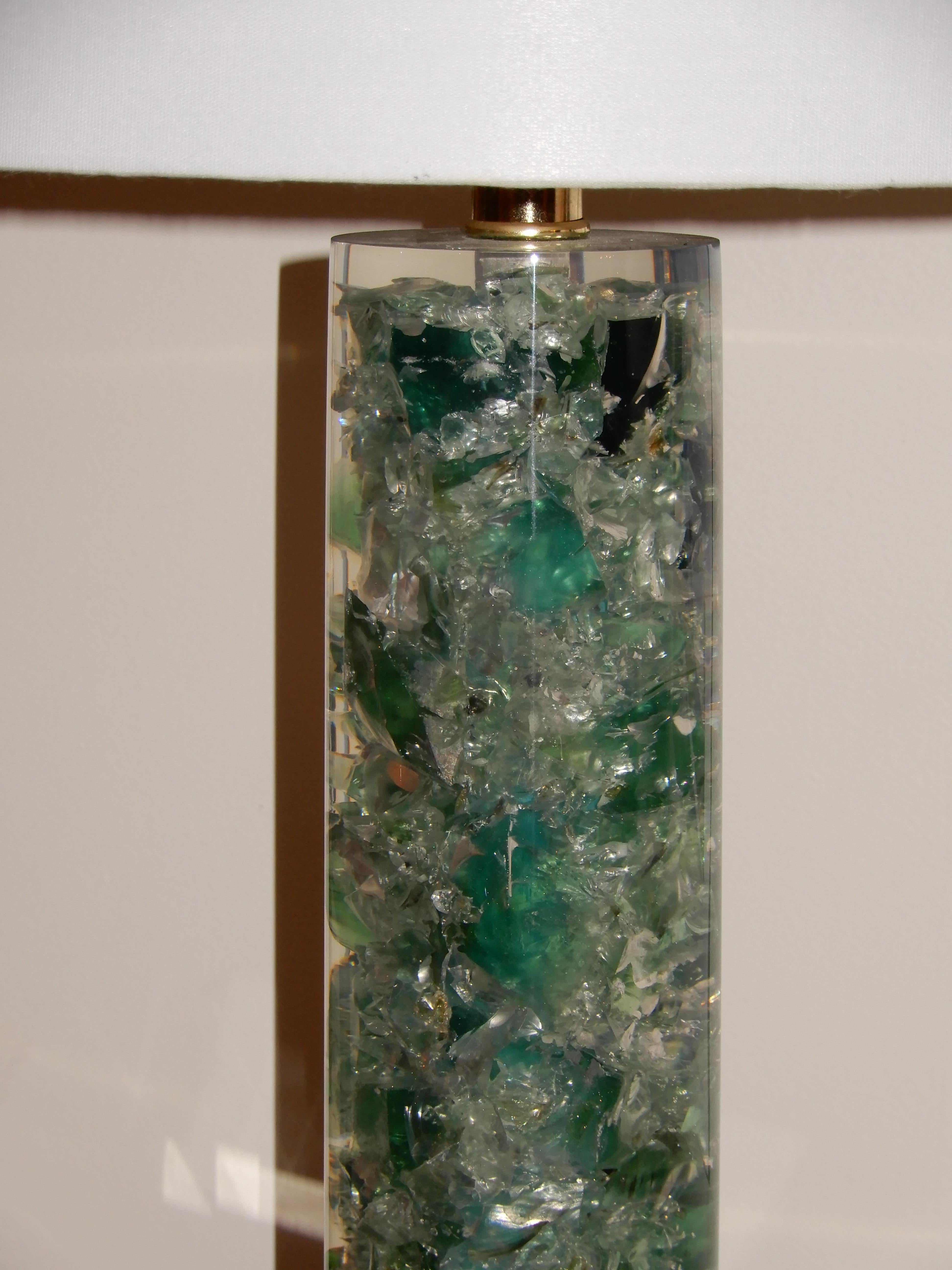 A lovely Lucite and crushed sea glass table lamp, blues, greens, turquoise, three-way switch up to 150 watts.
Lucite base and cylinder, brass warm fittings. The lamp measures 28 inches from the base to the top of the shade and 22 inches to the
