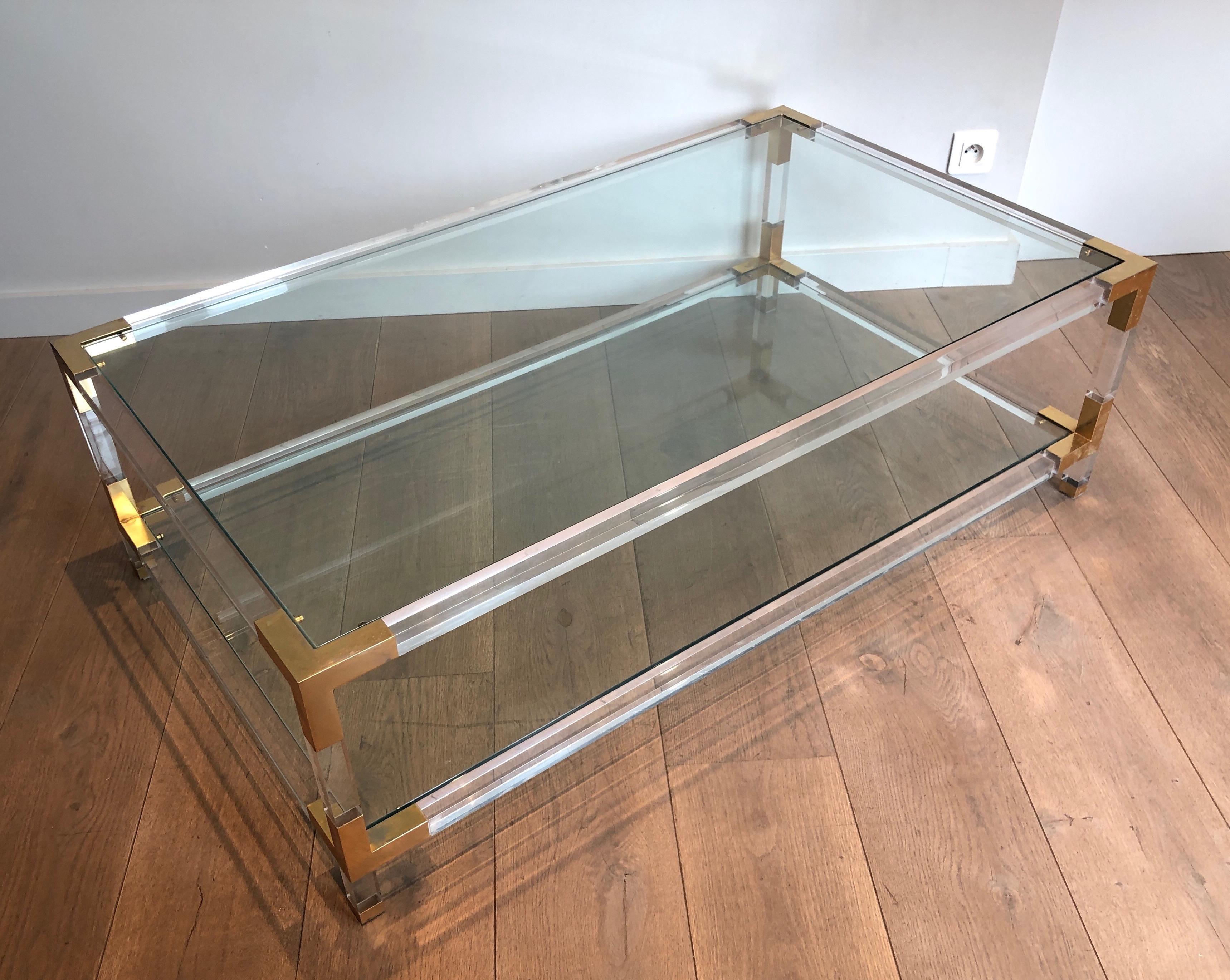 This very nice and elegant vintage coffee table is made of lucite with gilt chrome corners. This is a work in the style of famous French designer Maison Jansen. Circa 1970.