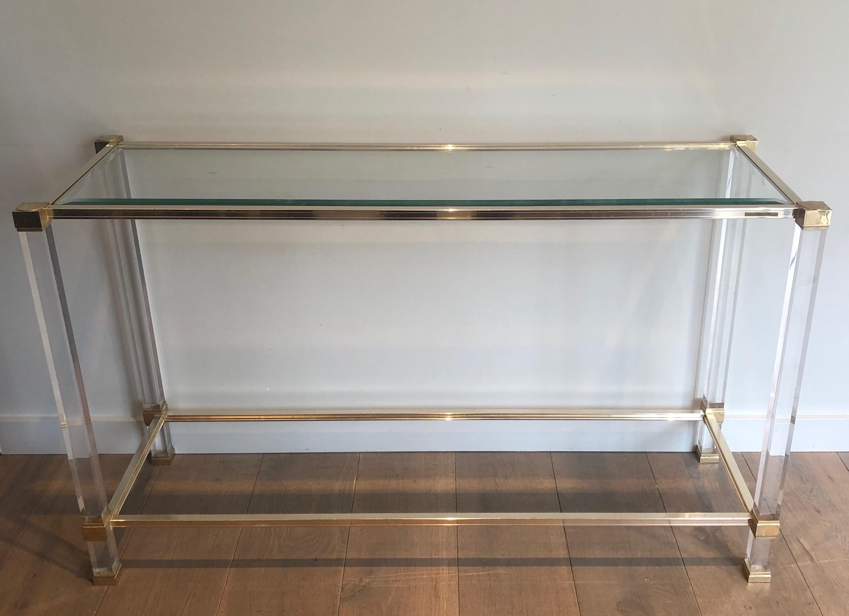 This very elegant console table is made of lucite and gilt metal. This is a work by famous French designer Pierre Vandel. Circa 1970.