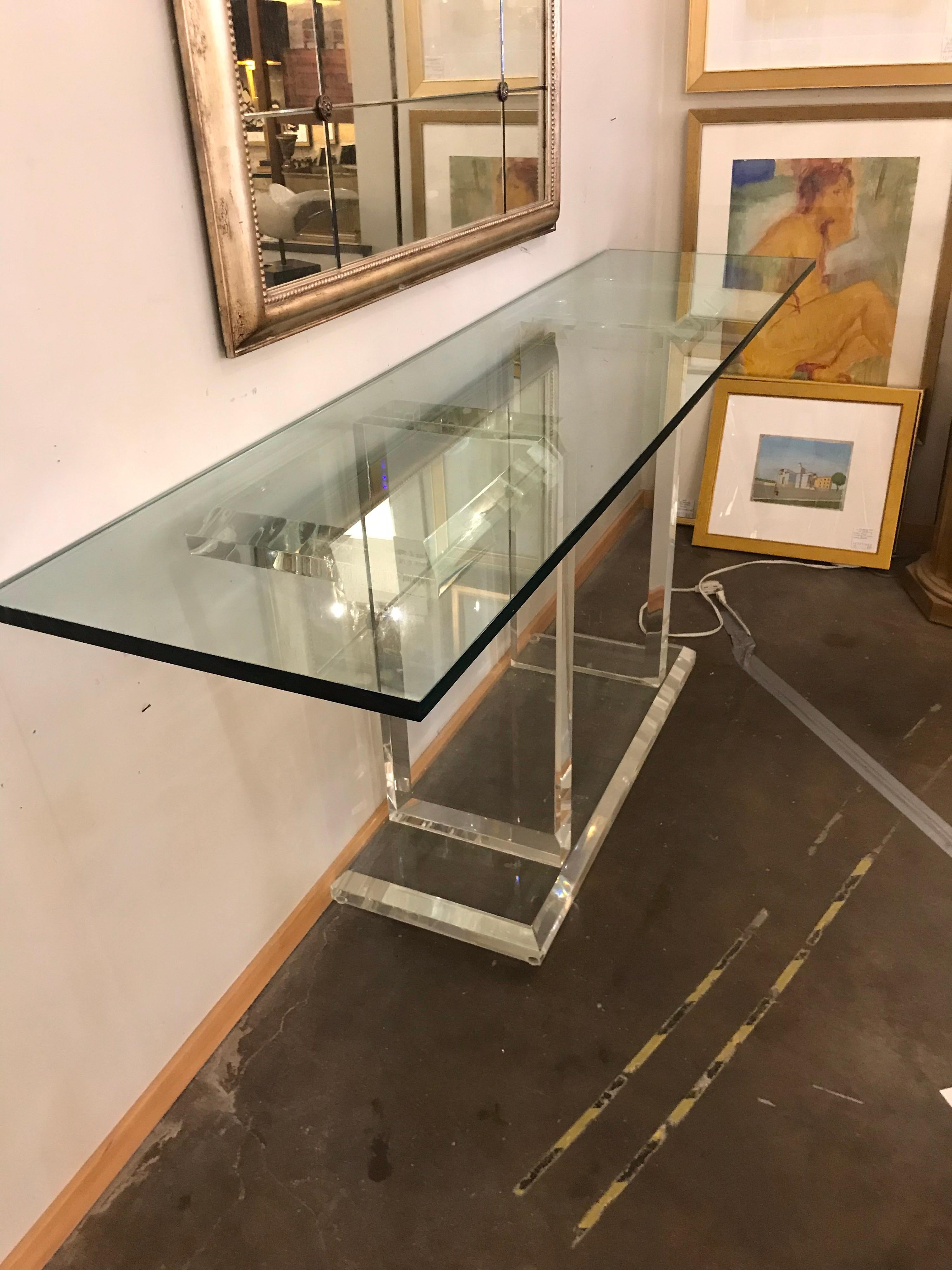 This is a 1980s Lucite and glass console. The glass is 3/4 inch
thick and is separate from the Lucite.
