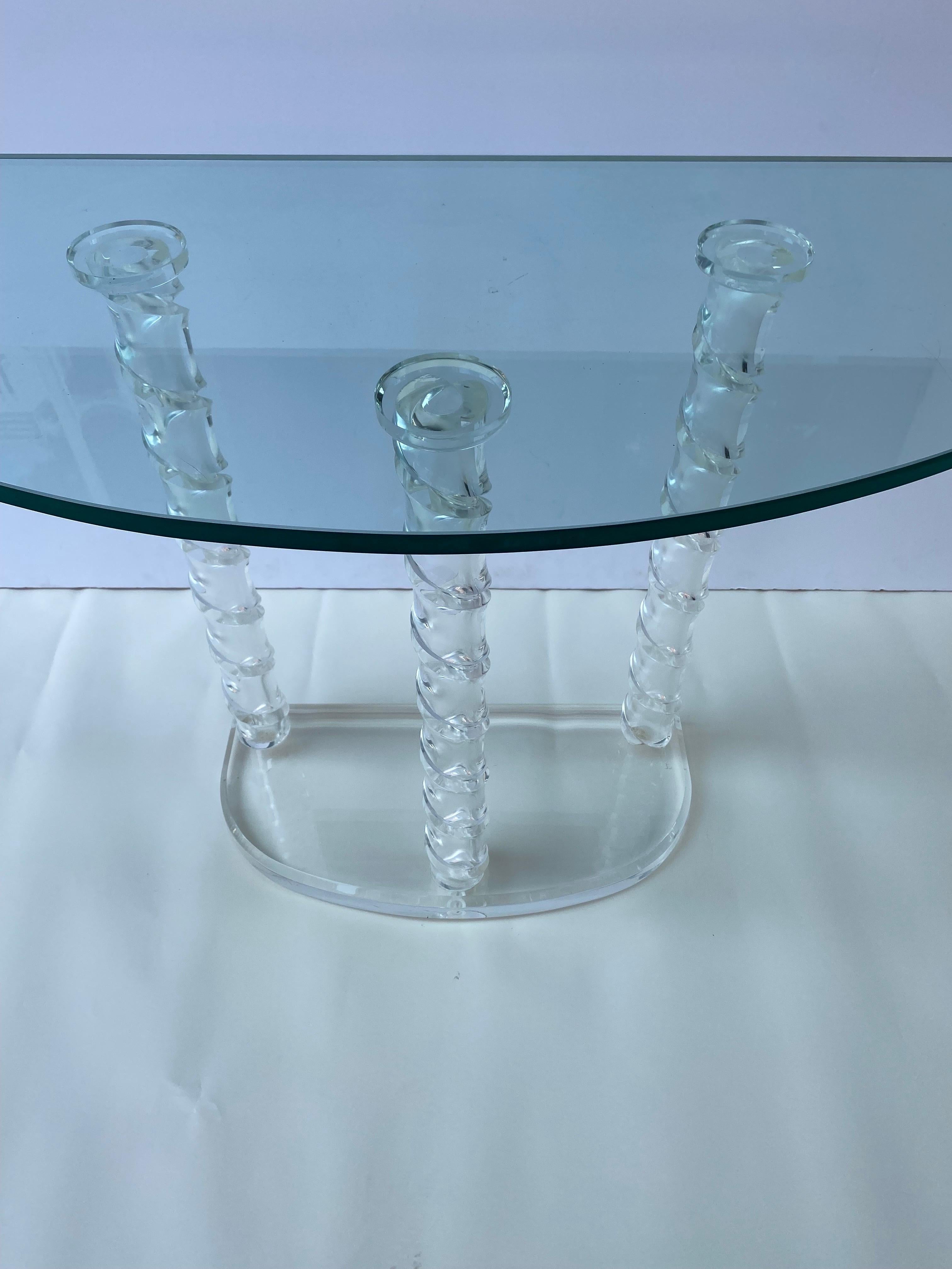 Lucite and glass console table. Rounded glass top sits on top of three twisted and carved Lucite Poles. Lucite Half Round Base. All in very nice Clean Original Condition. Lucite is very Clear! Measurements below are based on Top Currently on Table.