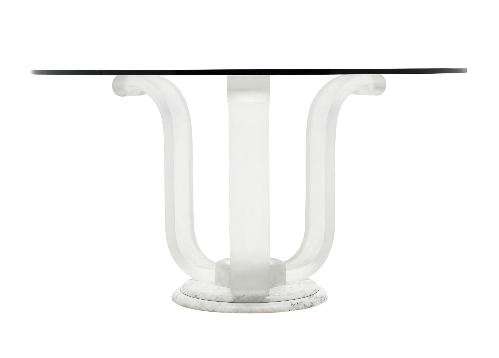 Tripod dining table with a base made of Lucite and marble. The glass circular top is round. We love the lines and quality of this vintage French piece.