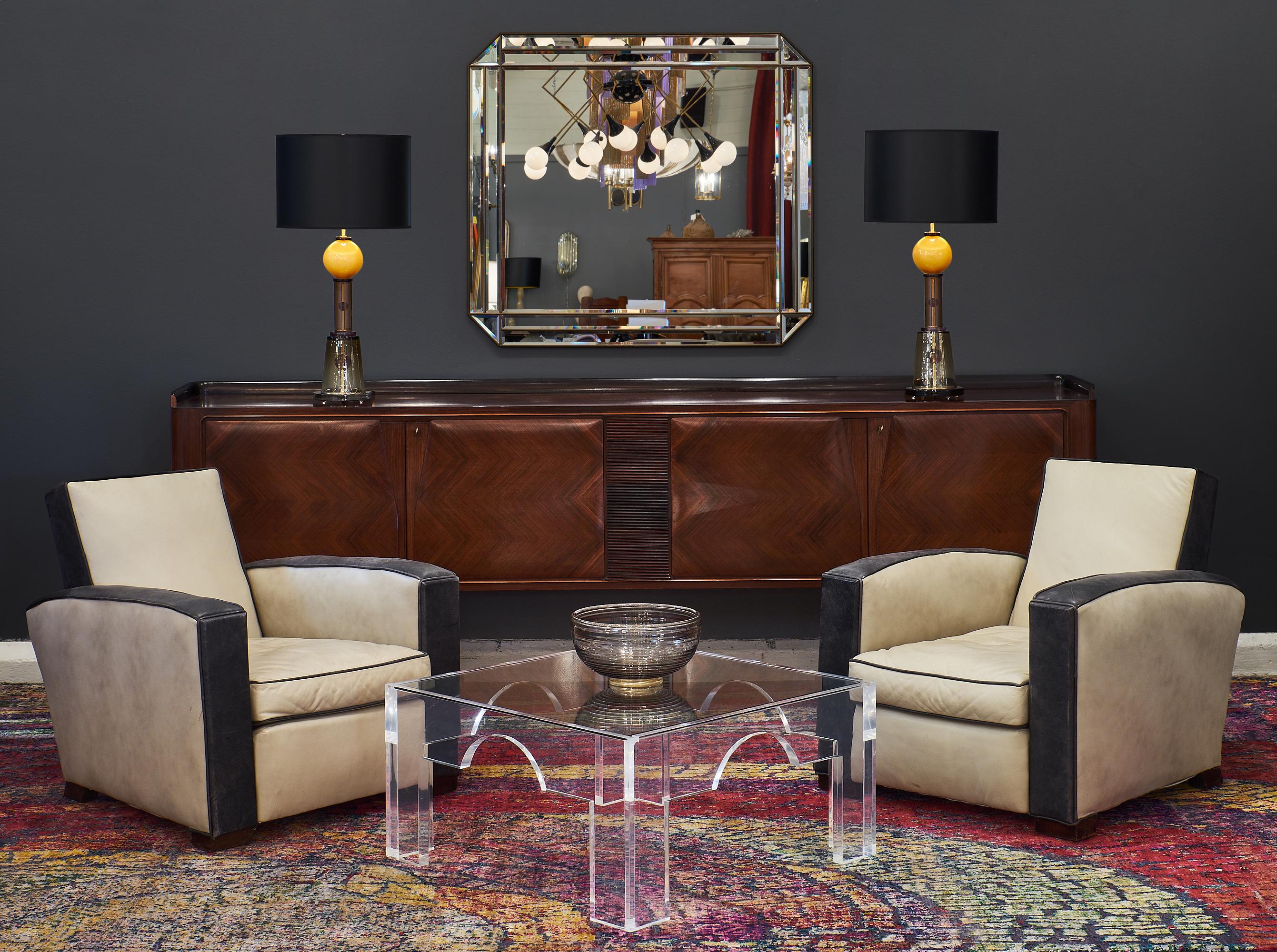 French Lucite and glass coffee tables. This rare pair of Lucite tables features clear glass tops and geometric forms. We love the high quality craftsmanship and square shape.