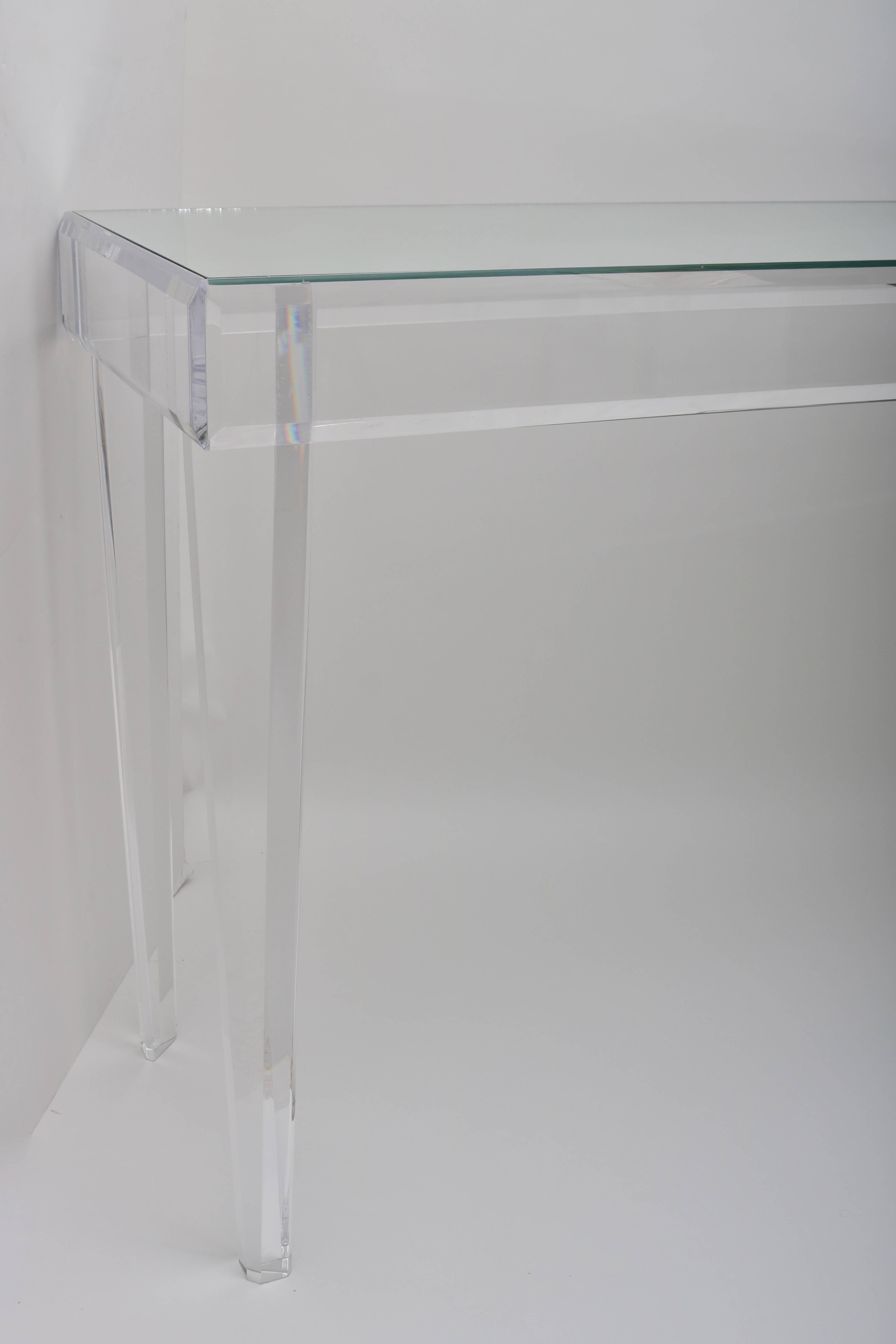 This stylish clean-lined Lucite and glass console table was designed and created by Iconic Snob Galeries.

Note:  We also have the same console available with a glass top.

 