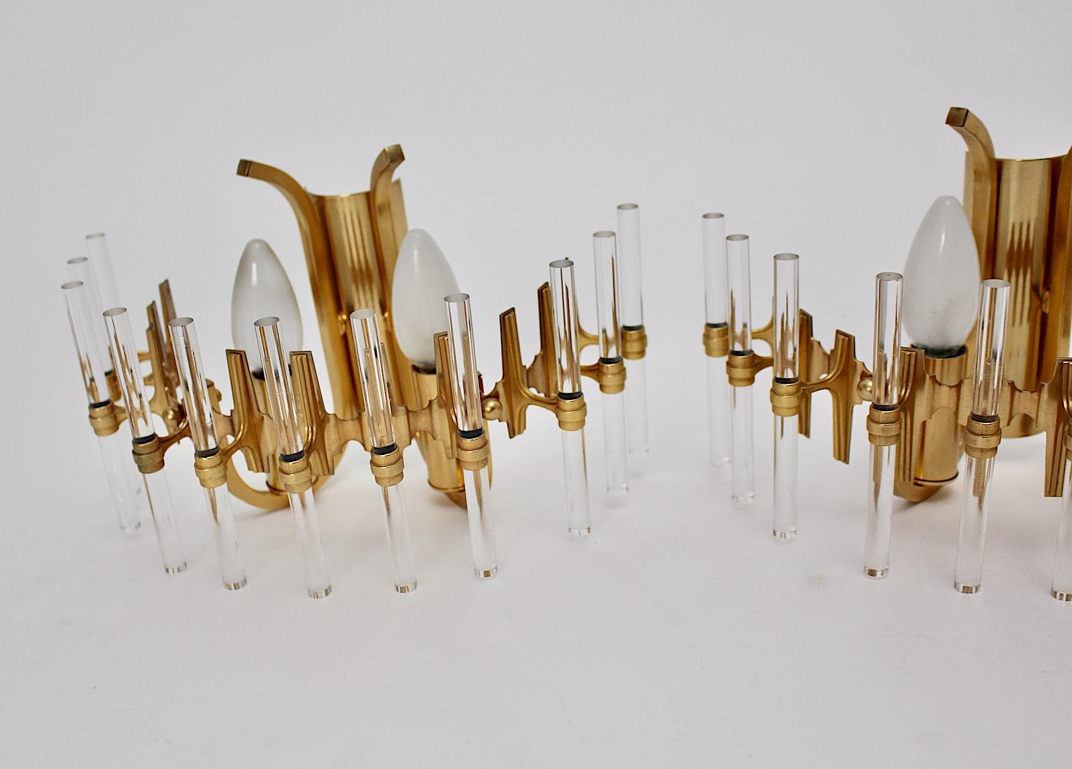 Modern vintage set of three sconces or wall lights from lucite and golden metal designed and manufactured, Italy, 1980s.
Each golden half round shaped sconce or wall light shows 11 lucite rods.
Each sconce has 2 E 14 sockets.
Very good condition