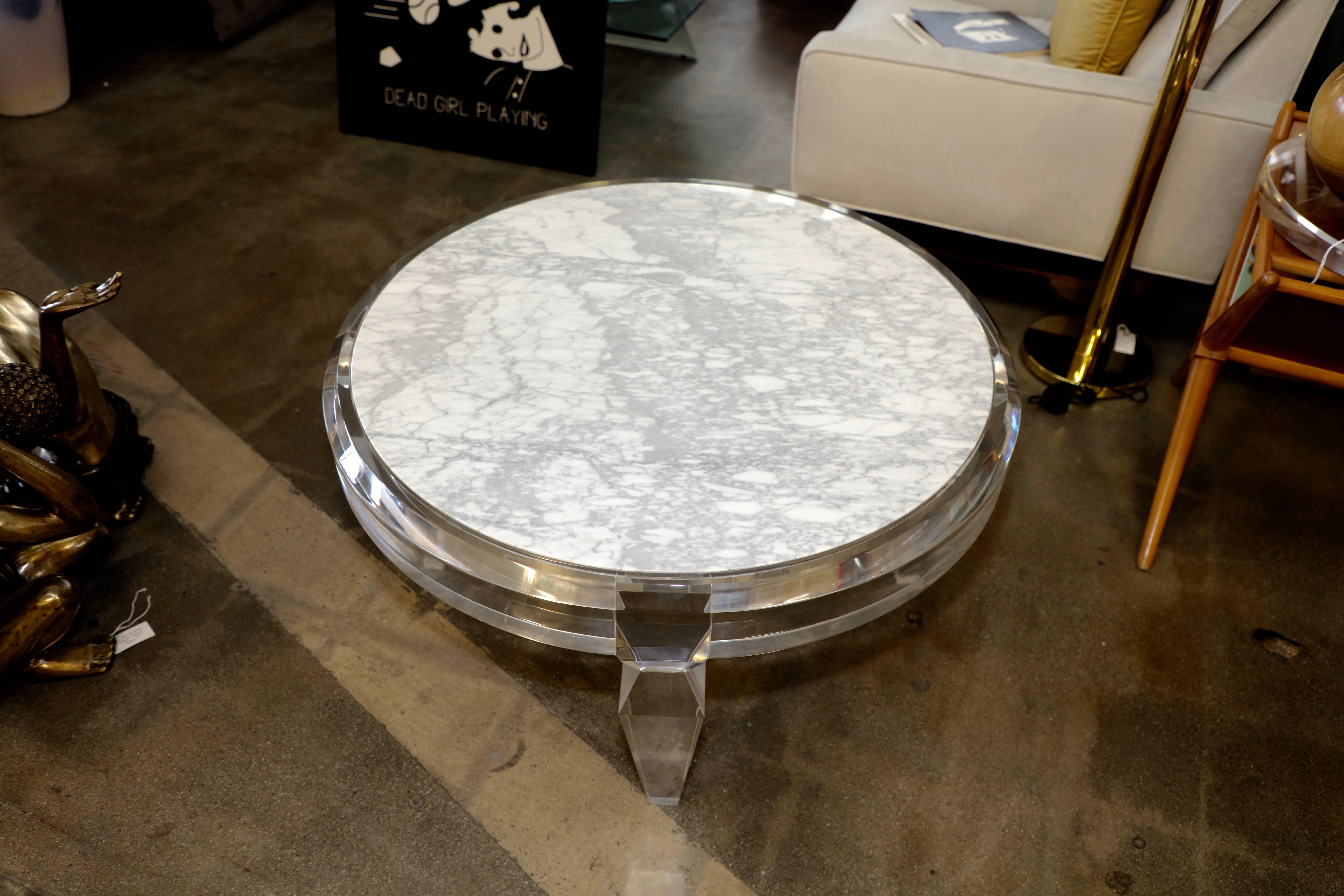 A nice Lucite and marble-top coffee table. It bears a CV sticker. Lucite has some marks and minor scratches. Marble appears in good condition with minor marks.