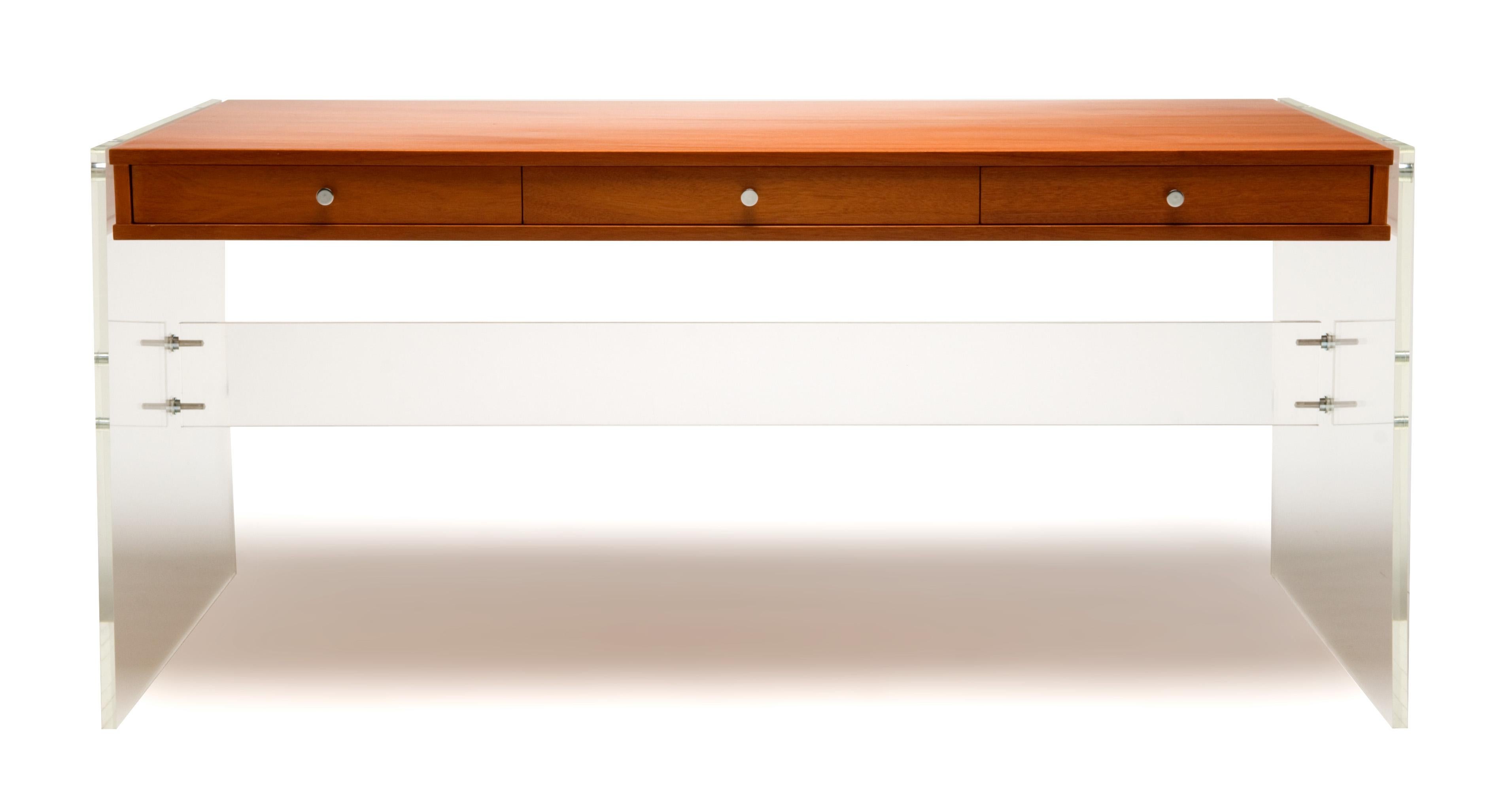 A highly engineered modernist desk made from a walnut (or oak, mahogany, or rosewood veneer) case “floating” on a Lucite base, which is affixed by custom-designed hardware. Custom sizes and finishes available.