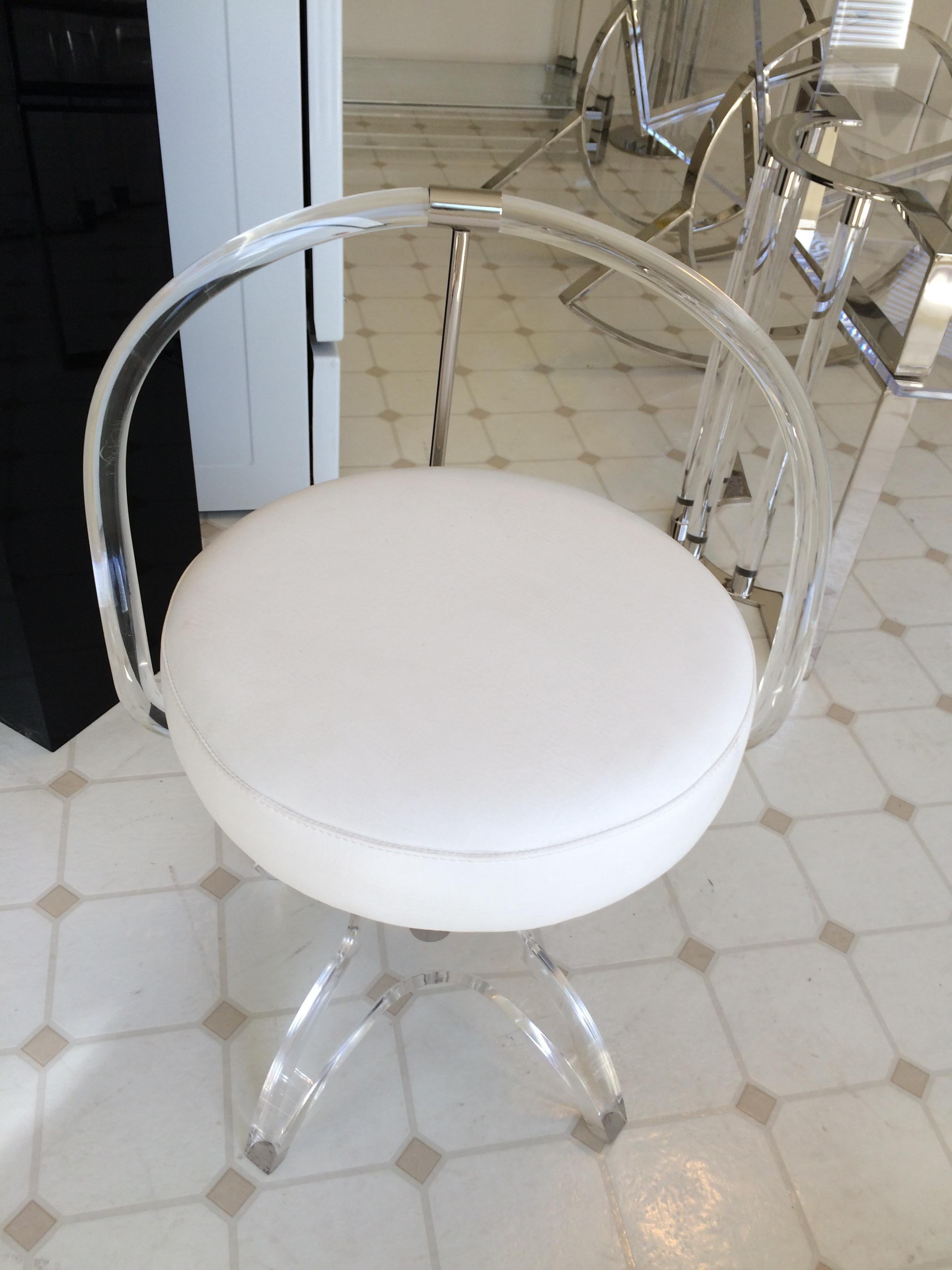 Stunning Lucite and nickel vanity chair designed by Charles Hollis Jones, the original and first design was in brass and commissioned by Lucille Ball, and this is the second edition made in Lucite and nickel and upholstered in white vinyl. The chair