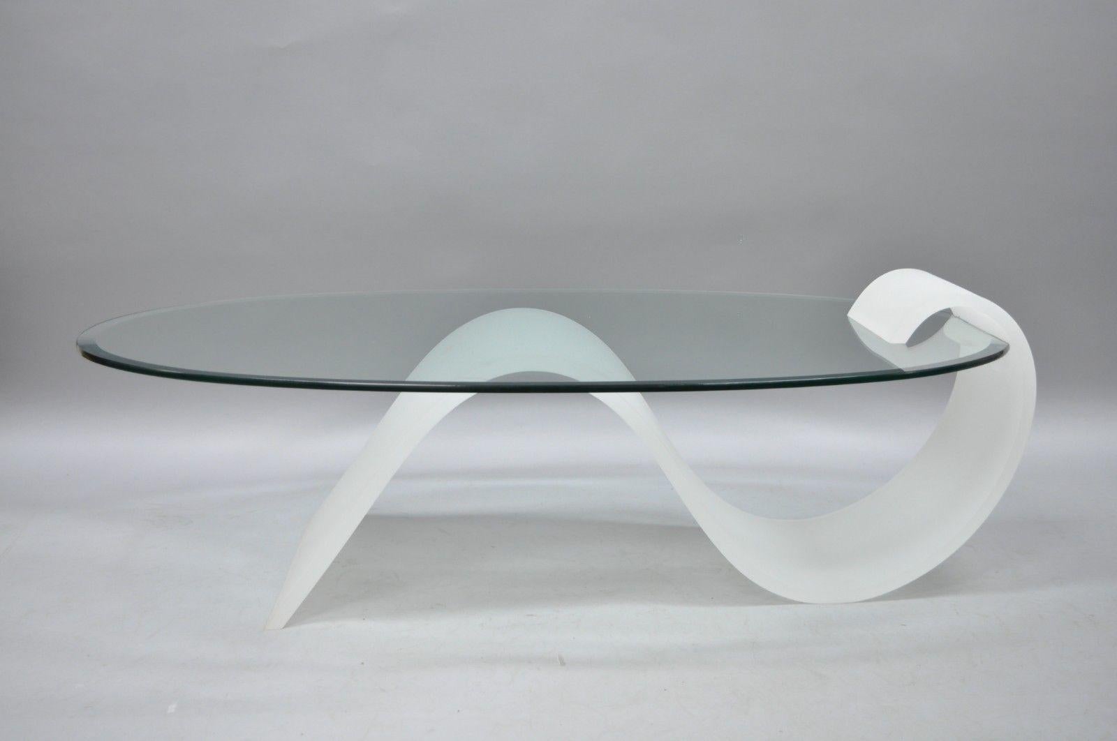Vintage sculptural Lucite and oval glass Mid-Century Modern s-shaped cantilever coffee table. Item features shapely frosted Lucite base, thick bevelled edge oval glass top, unique cantilever style construction, and sleek sculptural form, circa 1970.