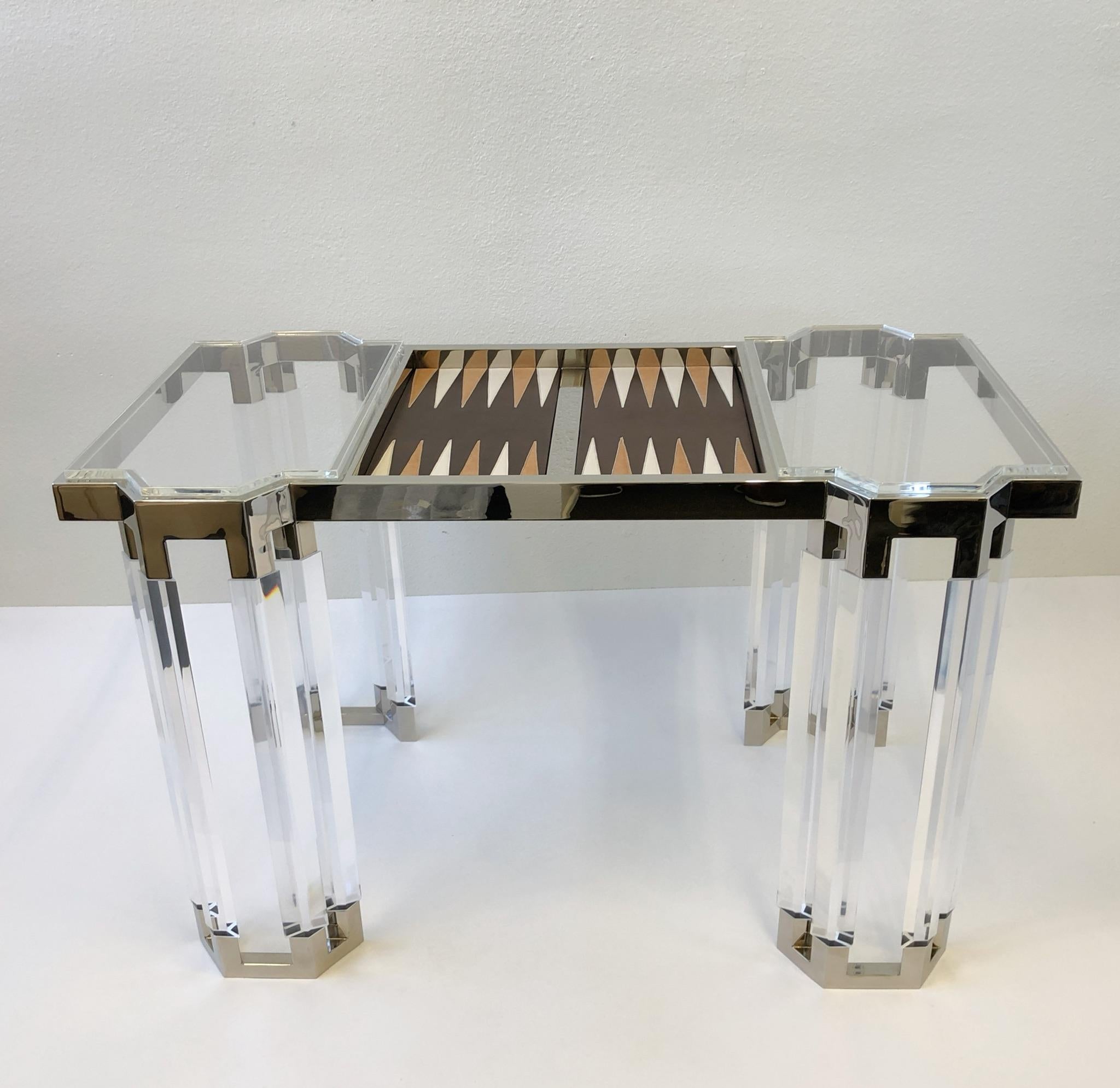 A studio clear Lucite and polish nickel backgammon table by renowned American designer Charles Hollis Jones. The table is part of his “Connection Diamond Line” the legs are diamond shape acrylic. The backgammon board is chocolate brown, off-white