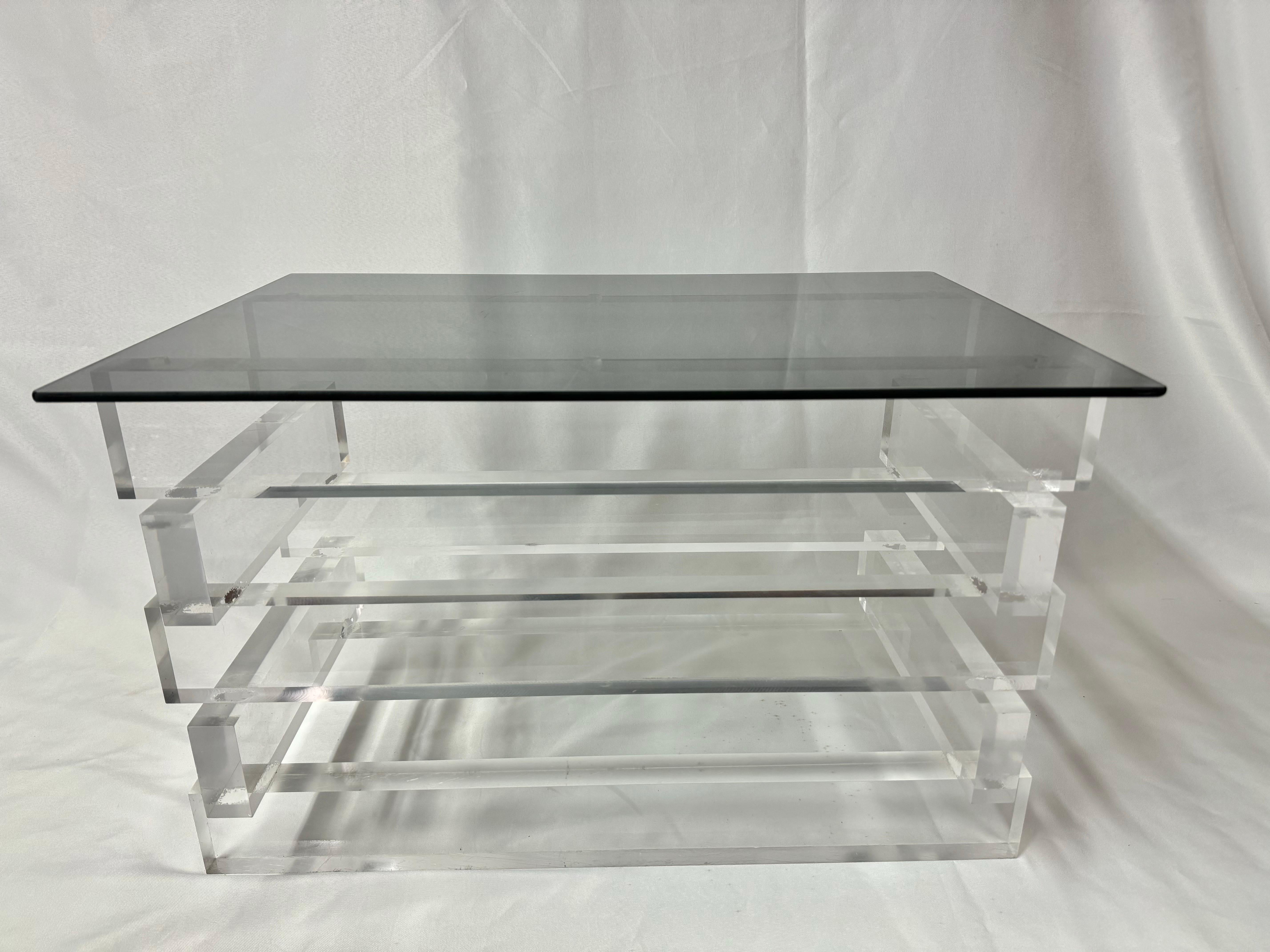 Stacked Lucite and Smoked Glass Table. Nice stacked horizontal design with a lovely contrasted top of smoked glass . Use as a small coffee table or use as a side table. In the style of Charles Hollis Jones. Another smaller matching table is also