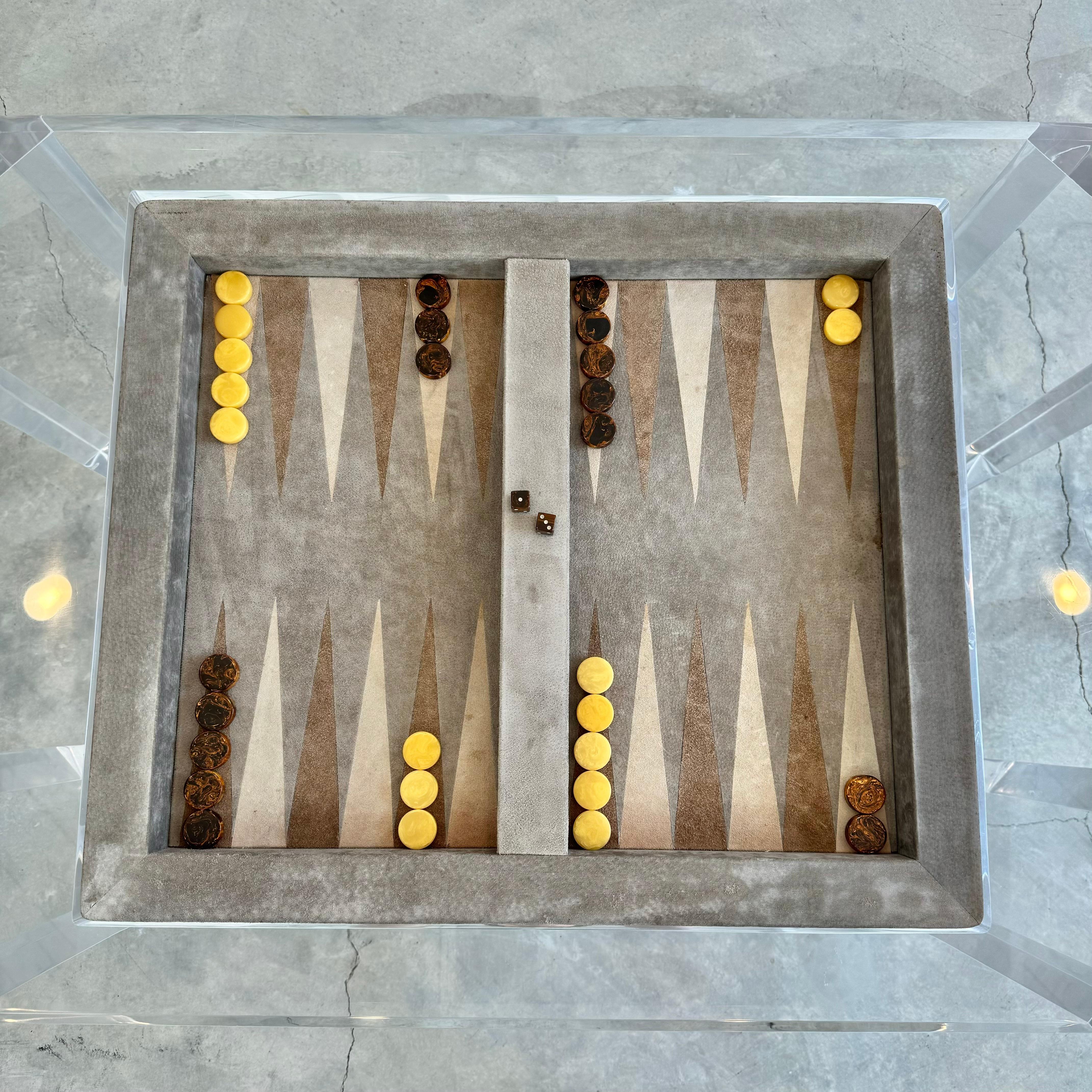 Faceted Lucite backgammon table with removable acrylic table top and suede inlay game table. Beautiful tan suede play surface with cream and brown suede triangles. Entire table is a thick clear Lucite giving this piece a great open feel and an