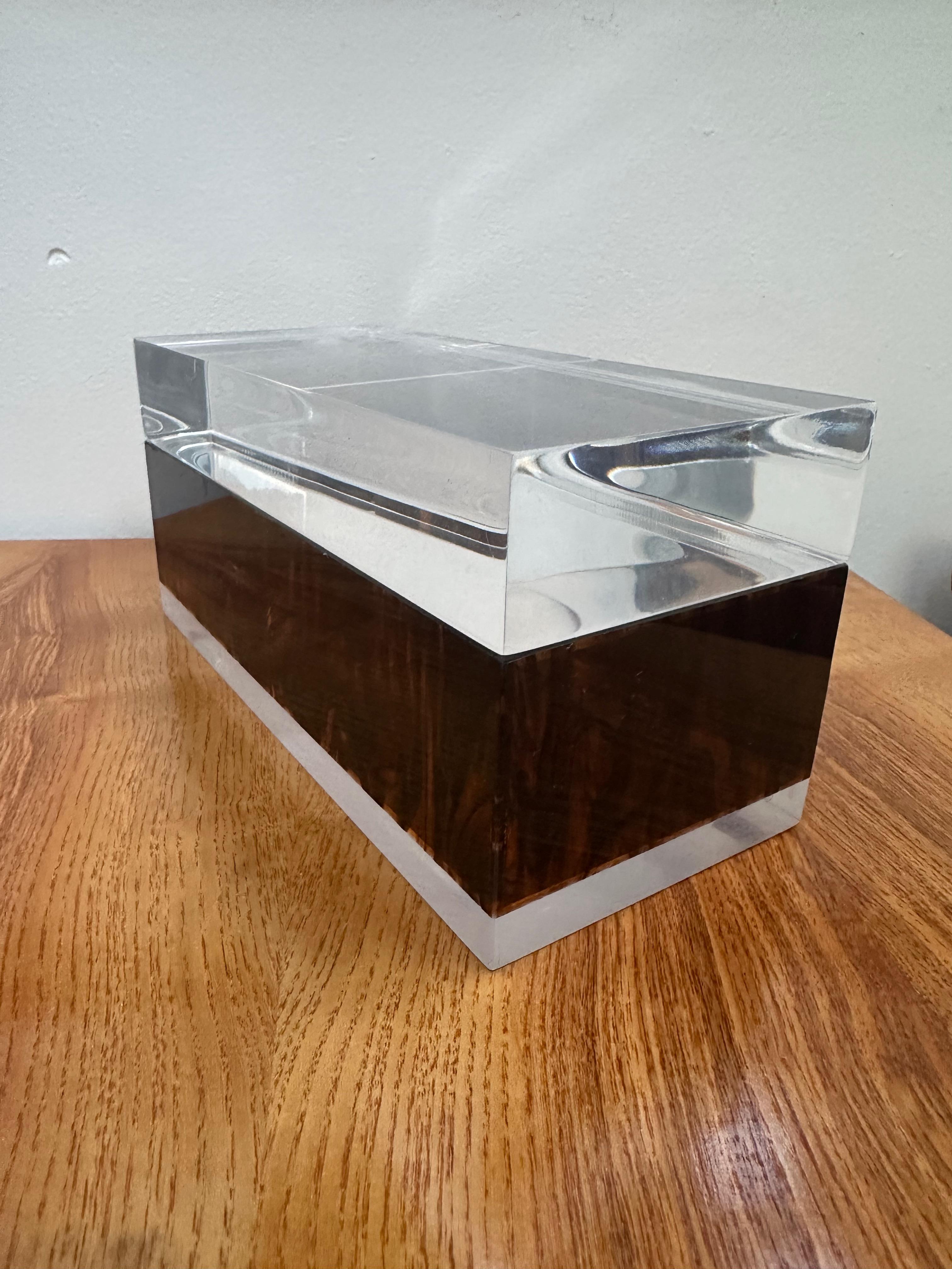 Exude elegance and sophistication with this exquisite Lucite and Tortoise shell Trinket Box by Philippe Cheverny. Crafted with the highest quality materials and meticulous attention to detail, this timeless piece adds a touch of glamour to any