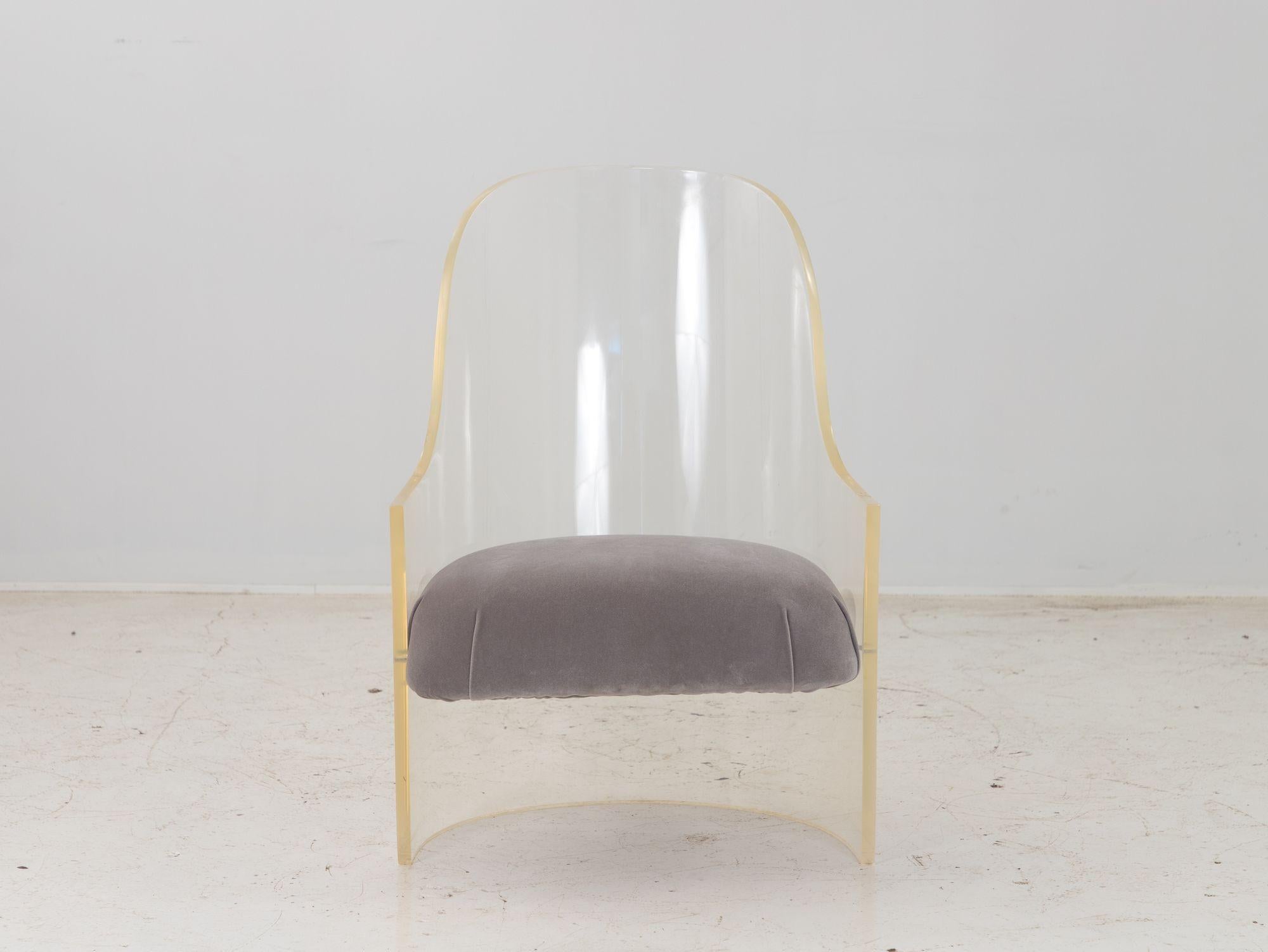 A 1970s lucite barrel back chair reupholstered in gray velvet. This chair is heavy for its size. Some wear to the lucite including a few scratches. Wear consistent with age and use. Measure: 16