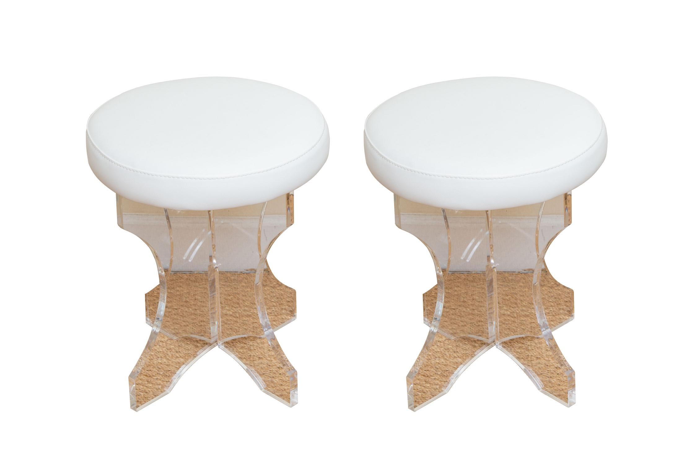 This pair of new old stock lucite vanity stools or small stools are from the 80's. They were manufactured from a lucite company from Miami back at the time. These have never been used but just stored in a warehouse. The white vinyl tops are clean.