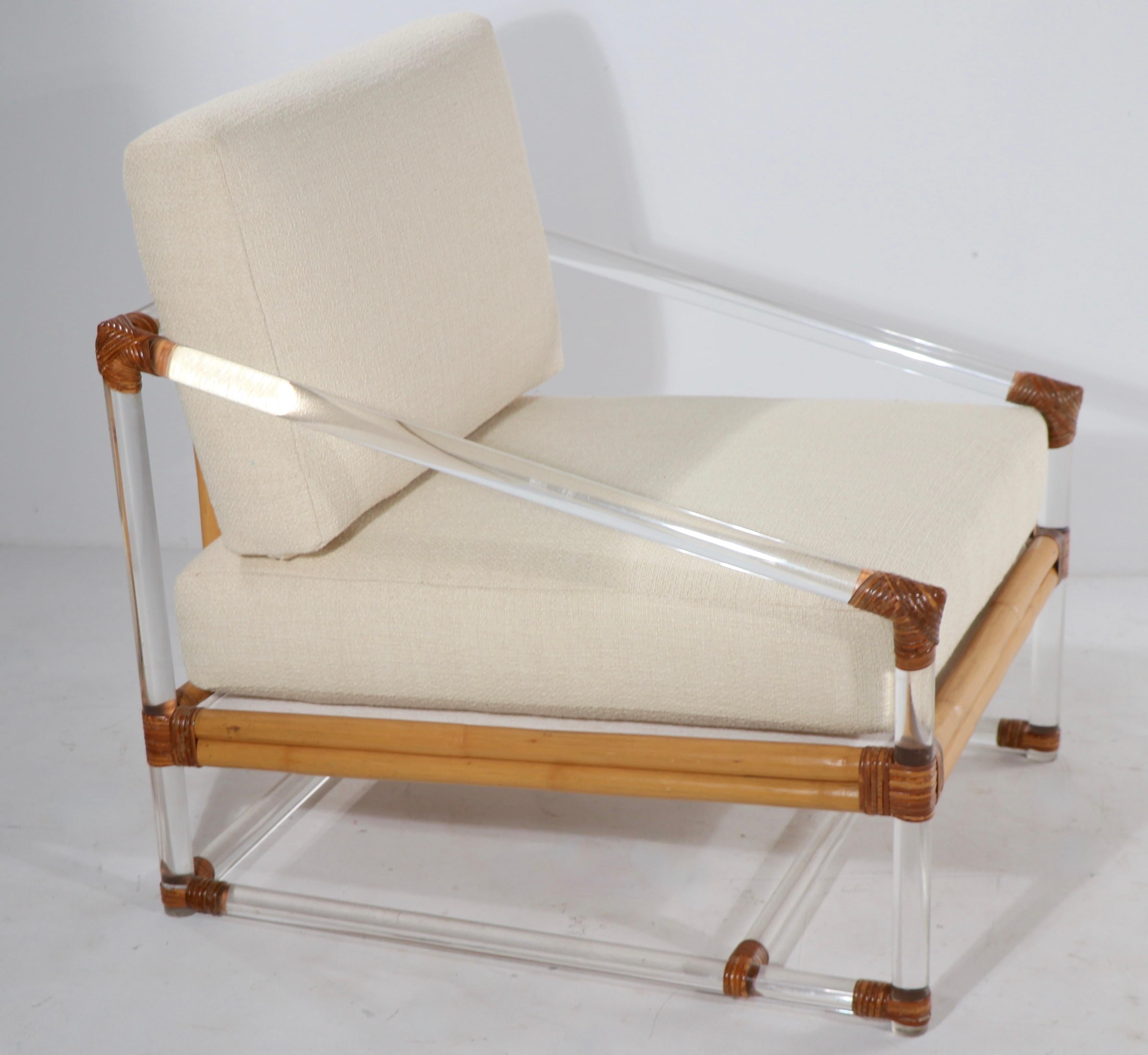 Exceptional lucite, wicker and upholstered lounge chair by McGuire. This example is in excellent condition, the cushions have been reupholstered - the lucite frame is in very good original condition, ready to use.