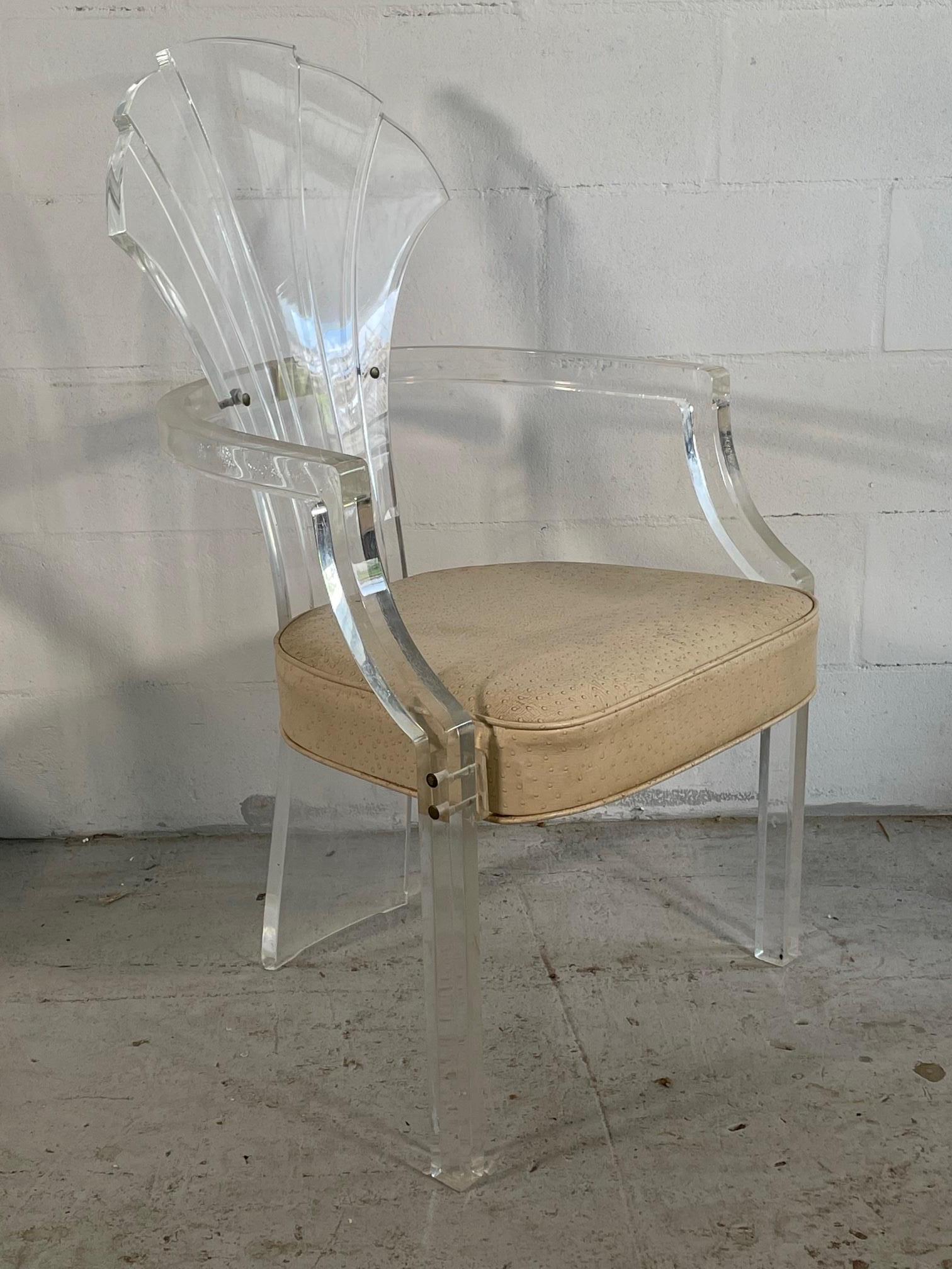 Set of four Art Deco style chairs feature full lucite frames and a unique shell form back. By HIll Manufacturing Corp,, circa 1980s. Very heavy and substantial. Faux ostrich upholstery. Good vintage condition with minimal wear and imperfections