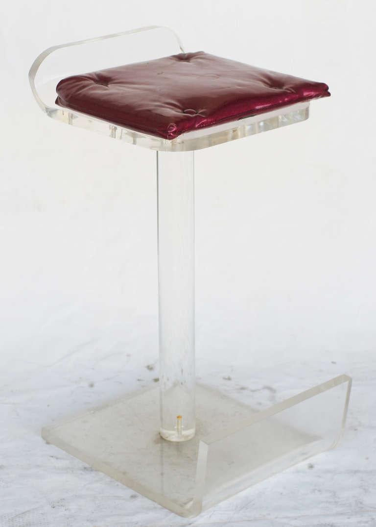 Lucite bar stools in the style of great artists, each featuring a footrest and magenta star dust vinyl seat pad.

Elevate your home bar or kitchen with our set of 4 Lucite bar stools. These sleek and modern stools combine form and function with