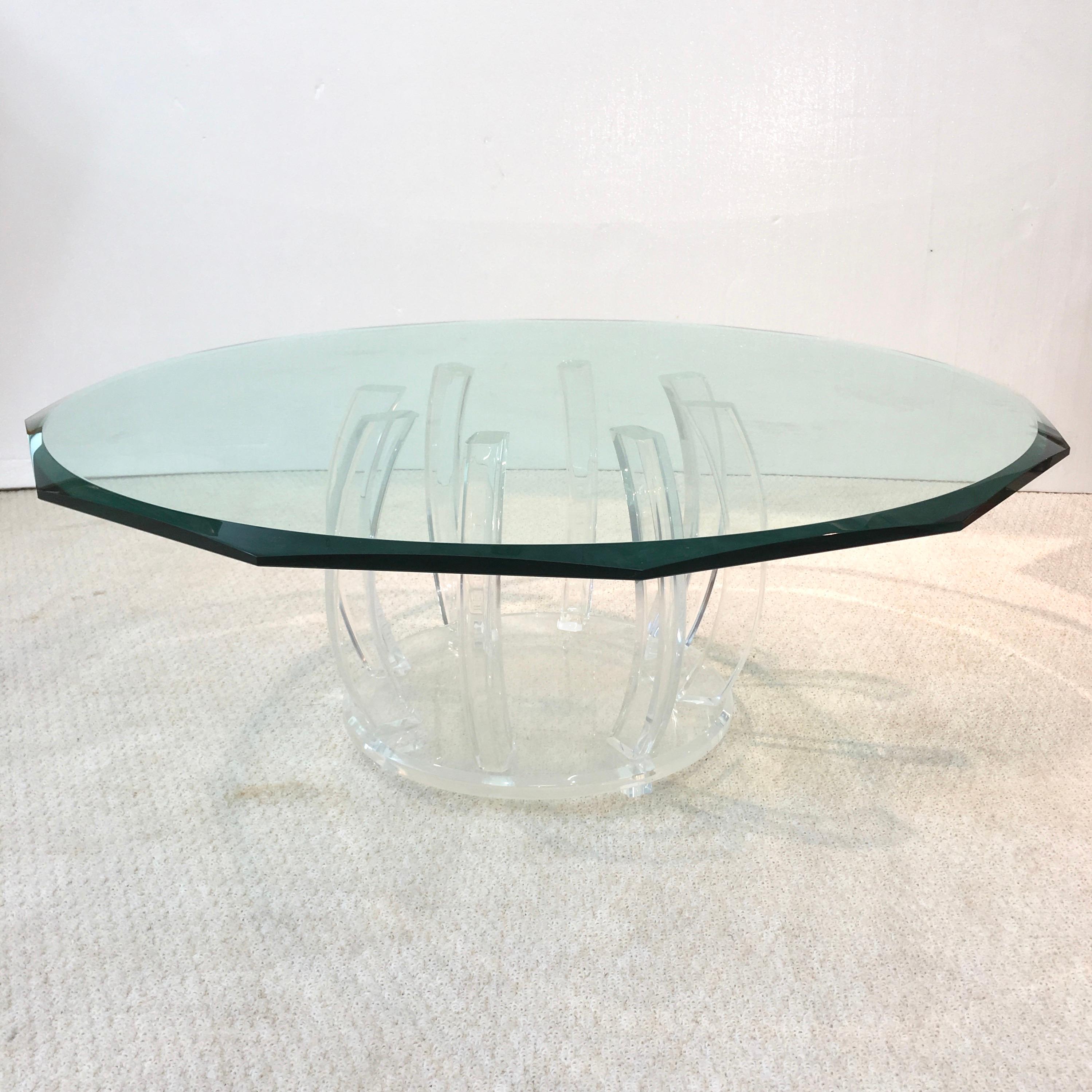 Acrylic barrel shaped cocktail table with eight ribs on a round Lucite base on four block feet supporting a stunning 1/2 inch thick twelve sided beveled glass top. 40.5 inch diameter by 15.5 inch height. Lucite cage drum base is 20.5 inches diameter