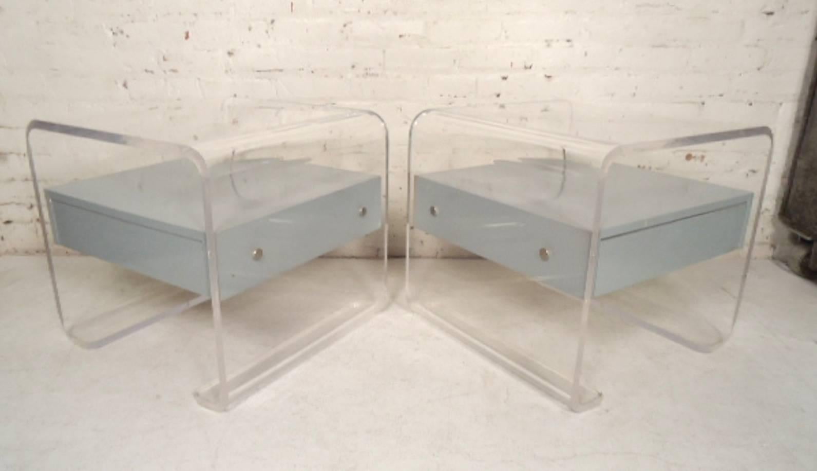 Mid-Century Modern style nightstands with grey or blue lacquer drawers and clear Lucite frames. 

(Please confirm item location - NY or NJ - with dealer).
   