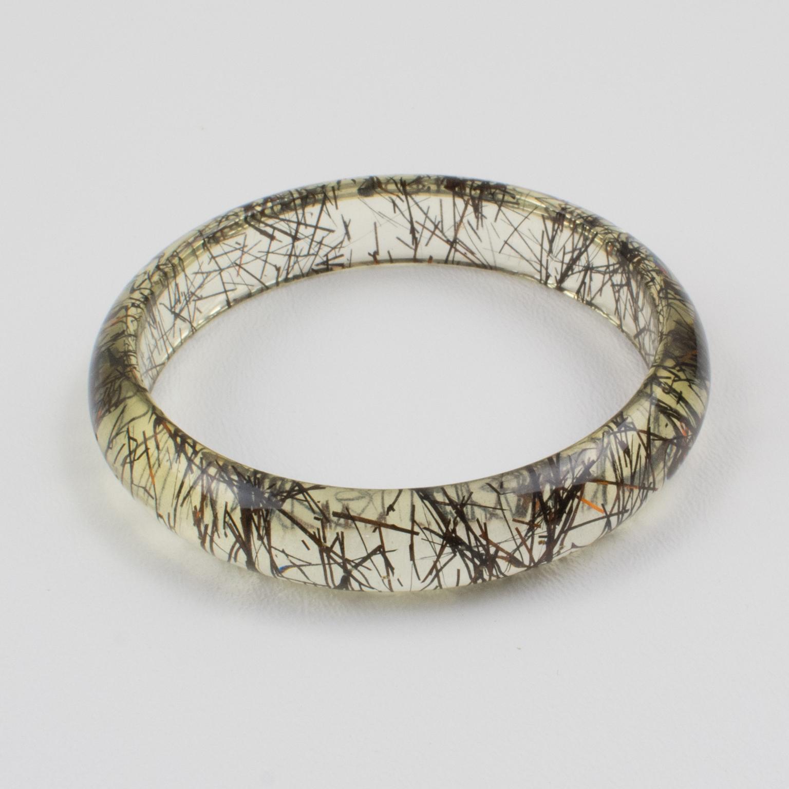 This lovely Lucite bracelet bangle has a domed shape and is comprised of clear Lucite injected with metallic thread inclusions in copper and black colors. The metallic threads sparkle like those of Christmas tinsel. There is no visible maker's