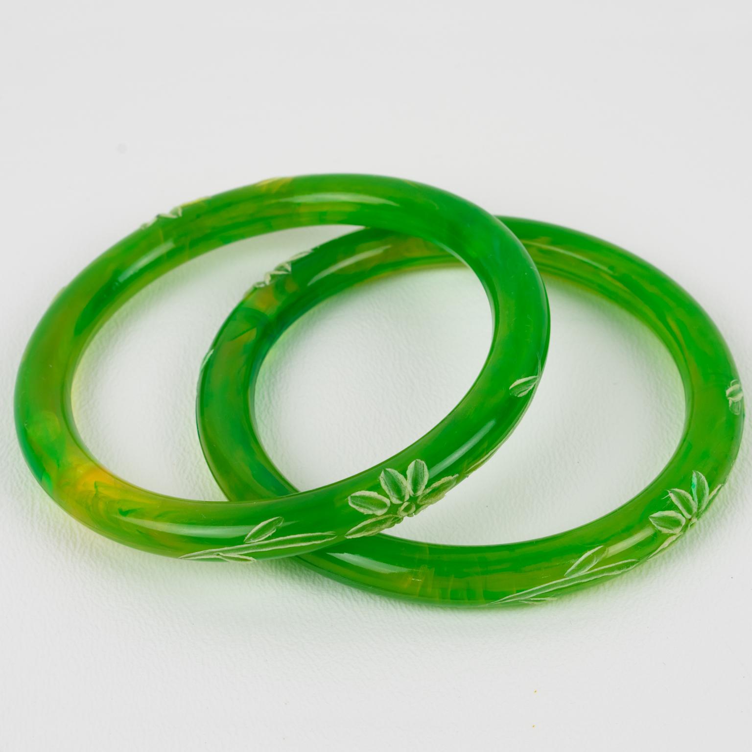 This is a lovely Lucite spacer bracelet bangle, a set of 2 pieces. The Lucite bangles are designed with a domed shape and boast a green grass swirl color with floral carving all around them. There is no visible maker's mark.
Measurements: Inside