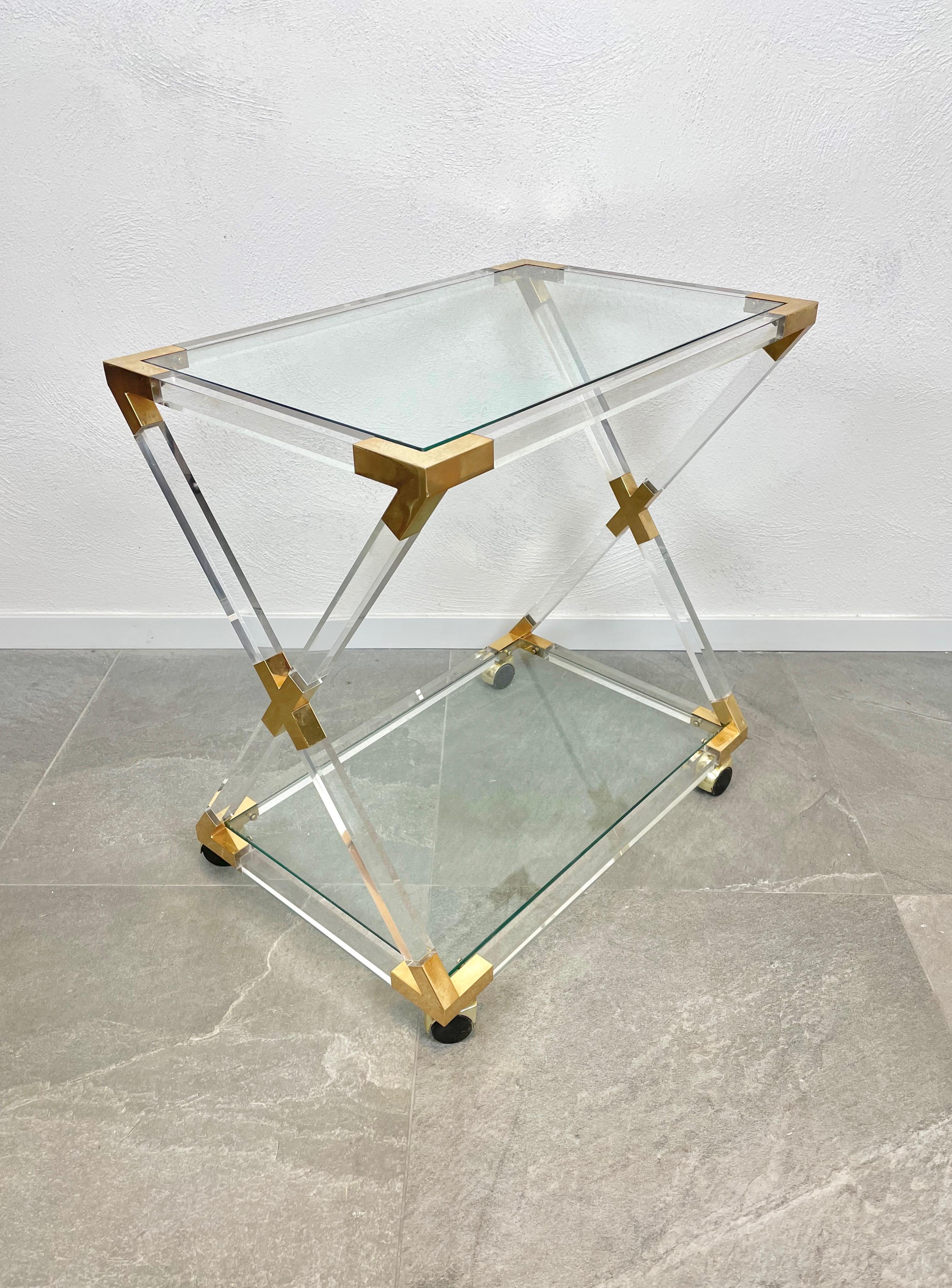 Serving cart in Lucite, glass and brass details featuring two glass shelves, in the style of Charles Hollis Jones.